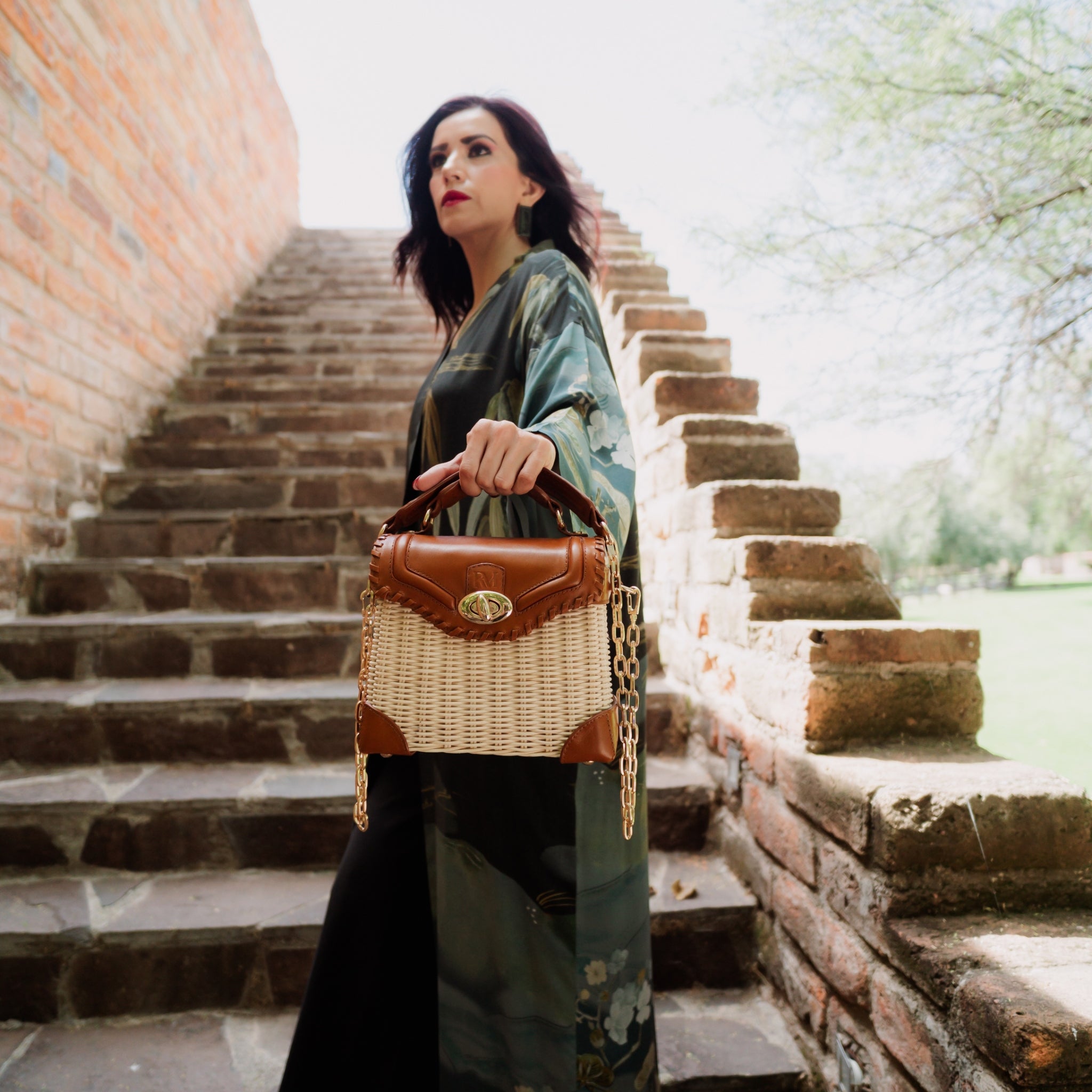 Wicker and top-grain leather handbag with structured silhouette, flap closure, and adjustable strap — elegant and lightweight