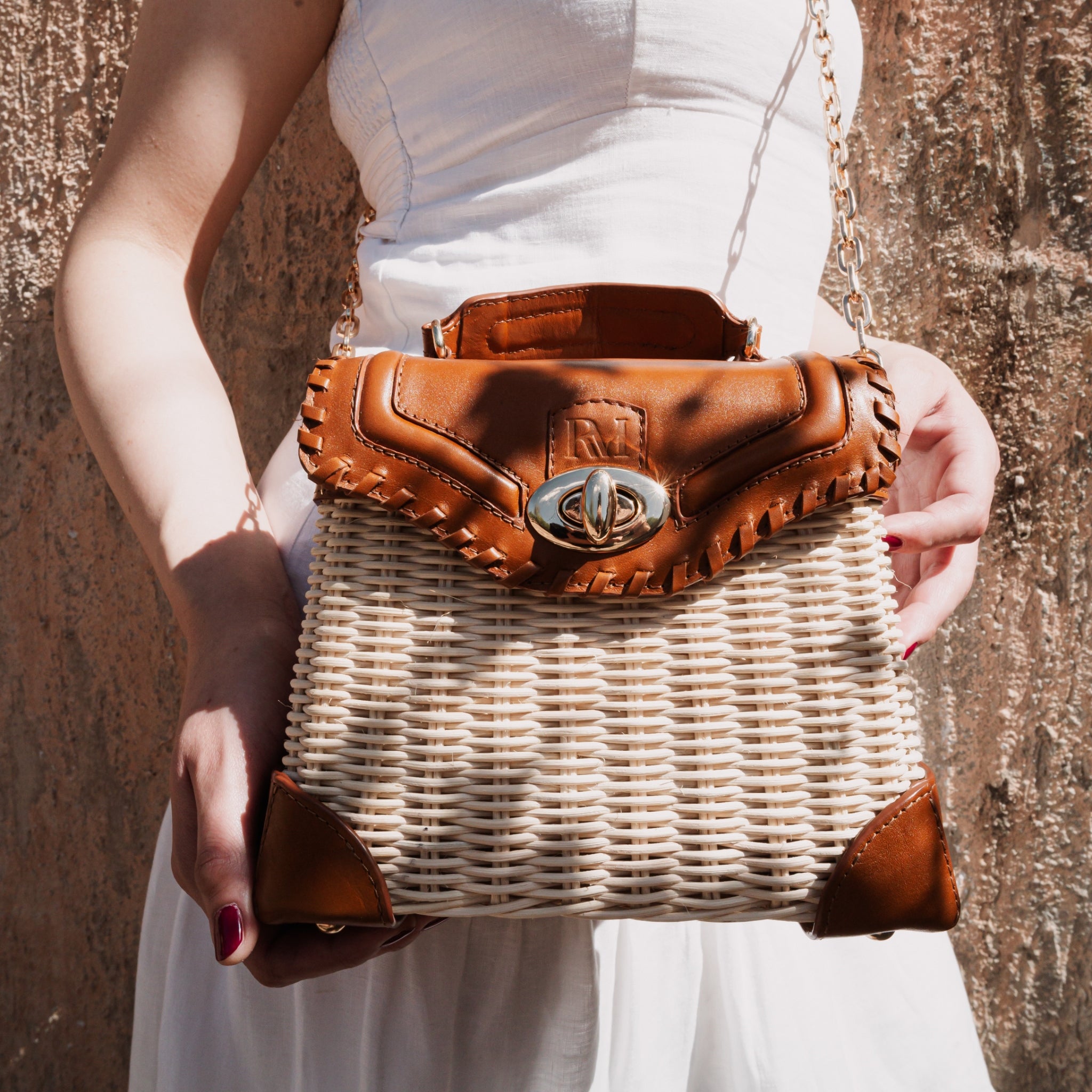 Wicker and top-grain leather handbag with structured silhouette, flap closure, and adjustable strap — elegant and lightweight