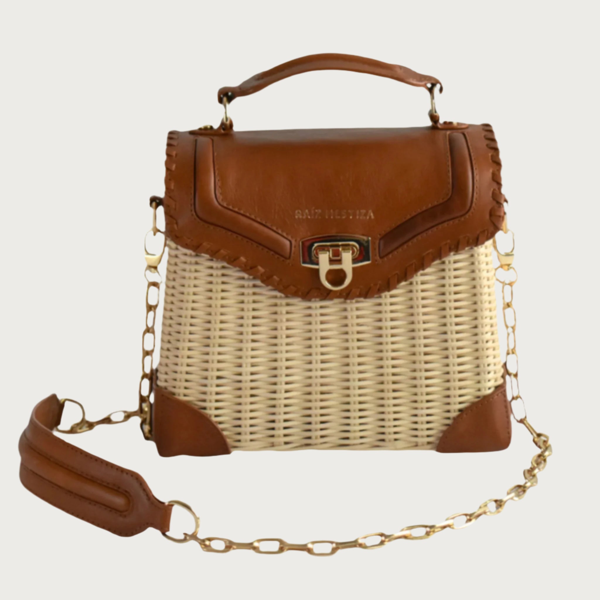 Wicker and top-grain leather handbag with structured silhouette, flap closure, and adjustable strap — elegant and lightweight