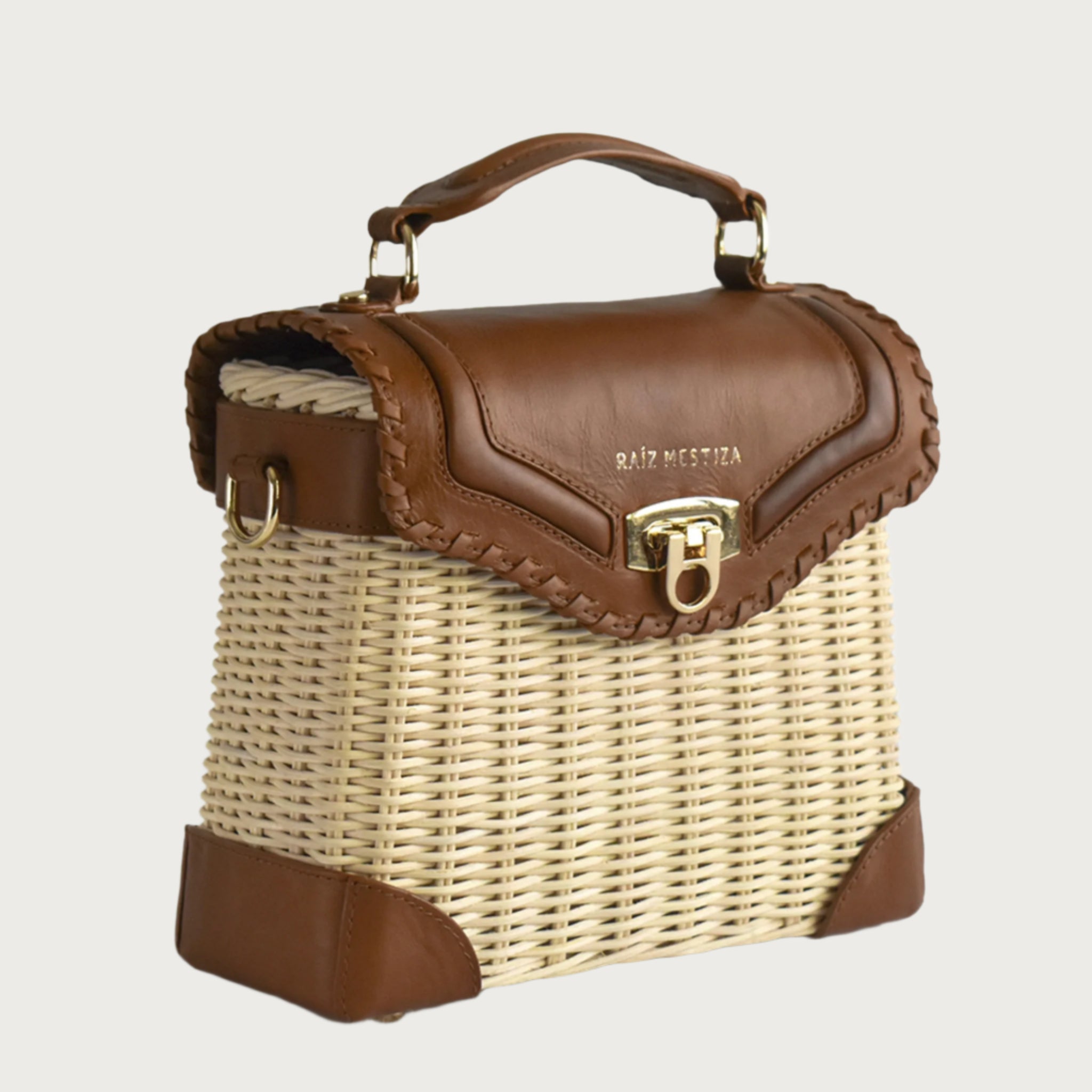 Wicker and top-grain leather handbag with structured silhouette, flap closure, and adjustable strap — elegant and lightweight