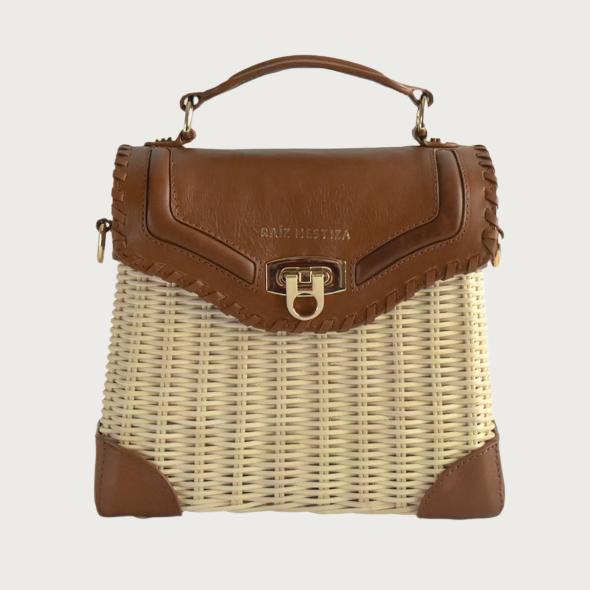 Wicker and top-grain leather handbag with structured silhouette, flap closure, and adjustable strap — elegant and lightweight
