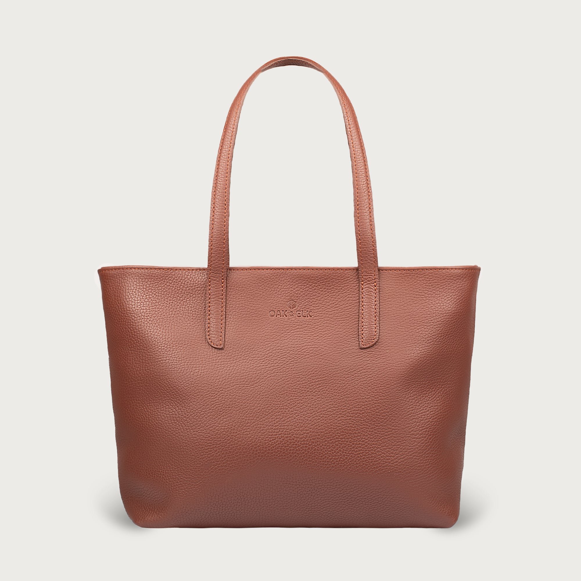 Leather tote made from top-grain leather, featuring smooth golden zipper, inner pouch, and structured design for daily use.