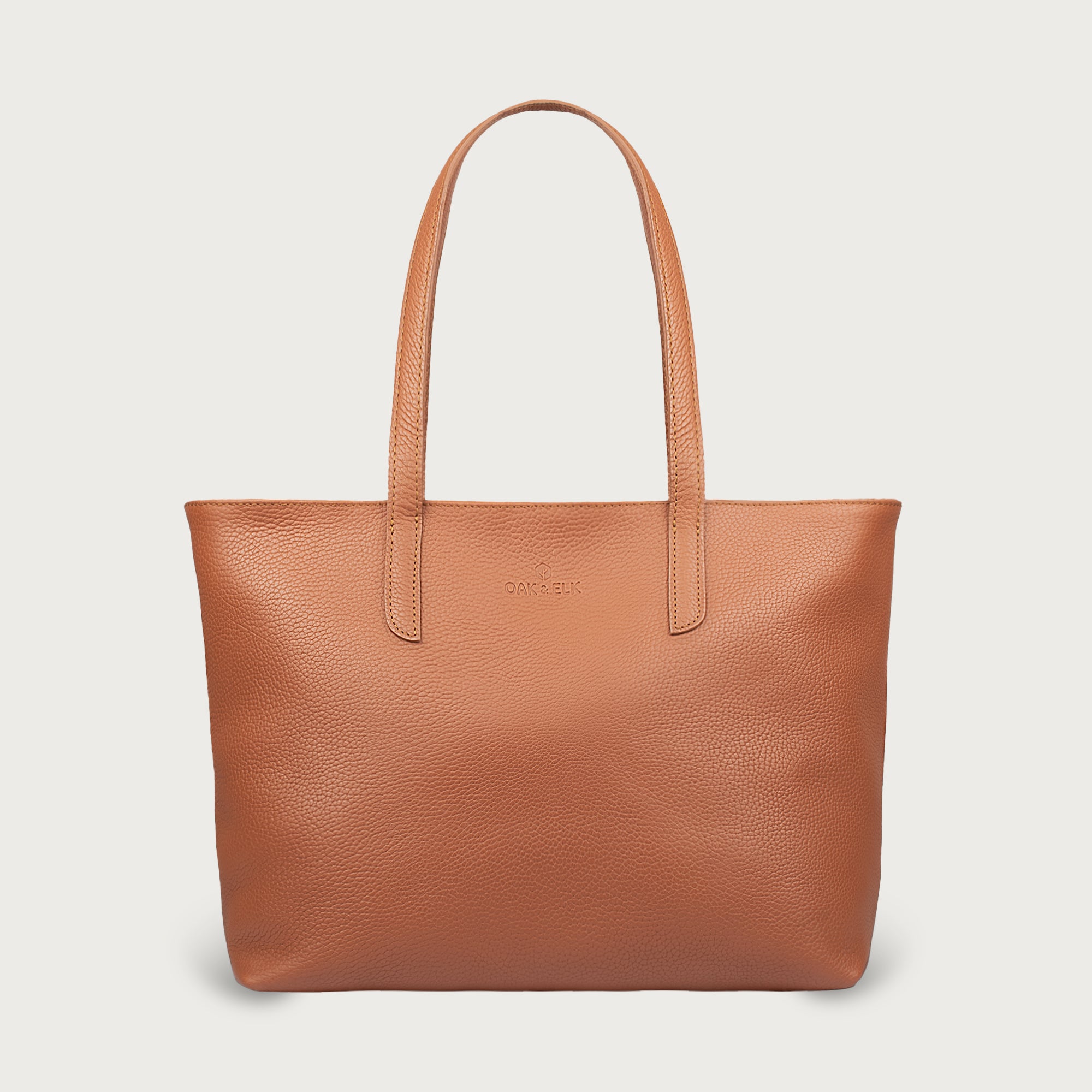 Leather tote made from top-grain leather, featuring smooth golden zipper, inner pouch, and structured design for daily use.