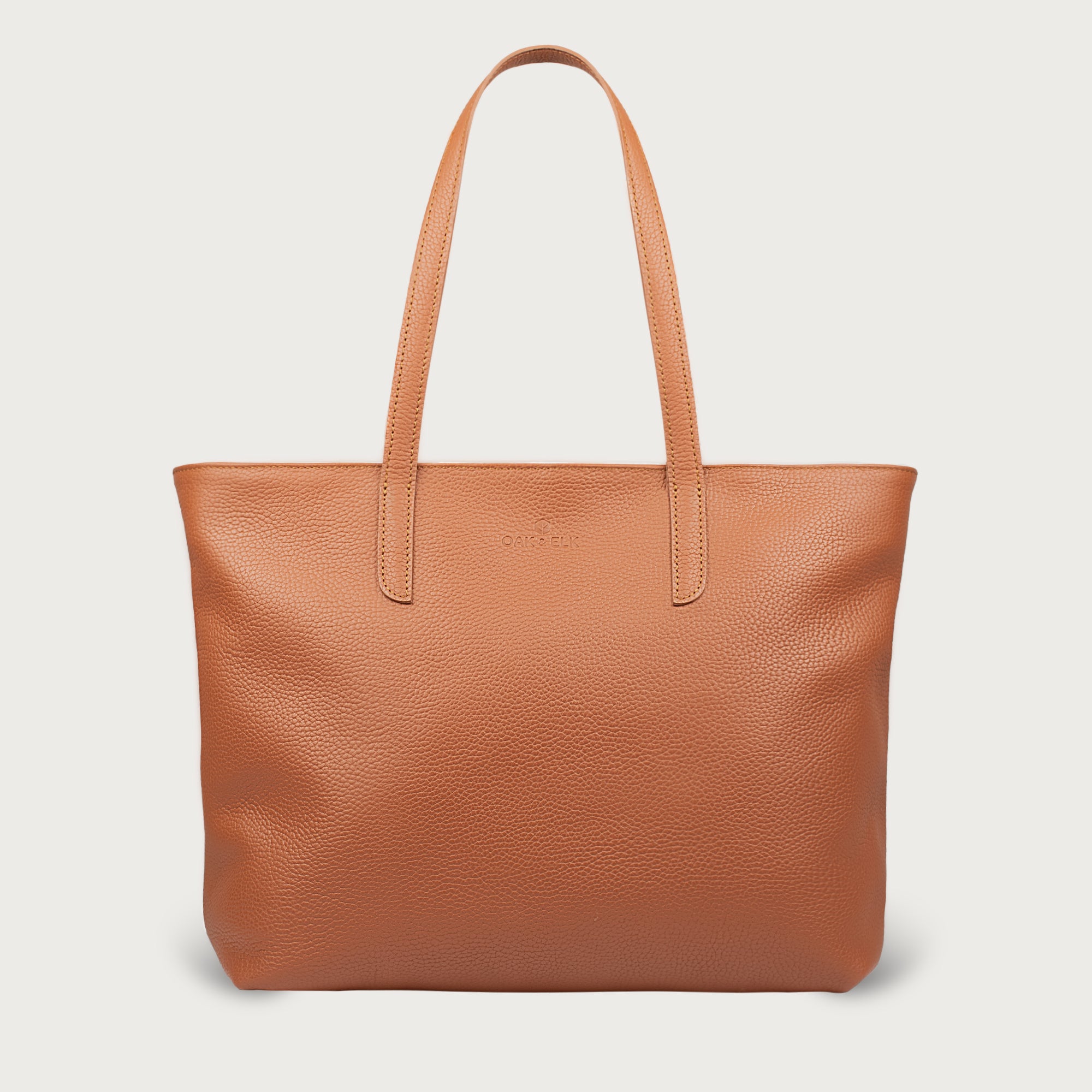 Leather tote made from top-grain leather, featuring smooth golden zipper, inner pouch, and structured design for daily use.