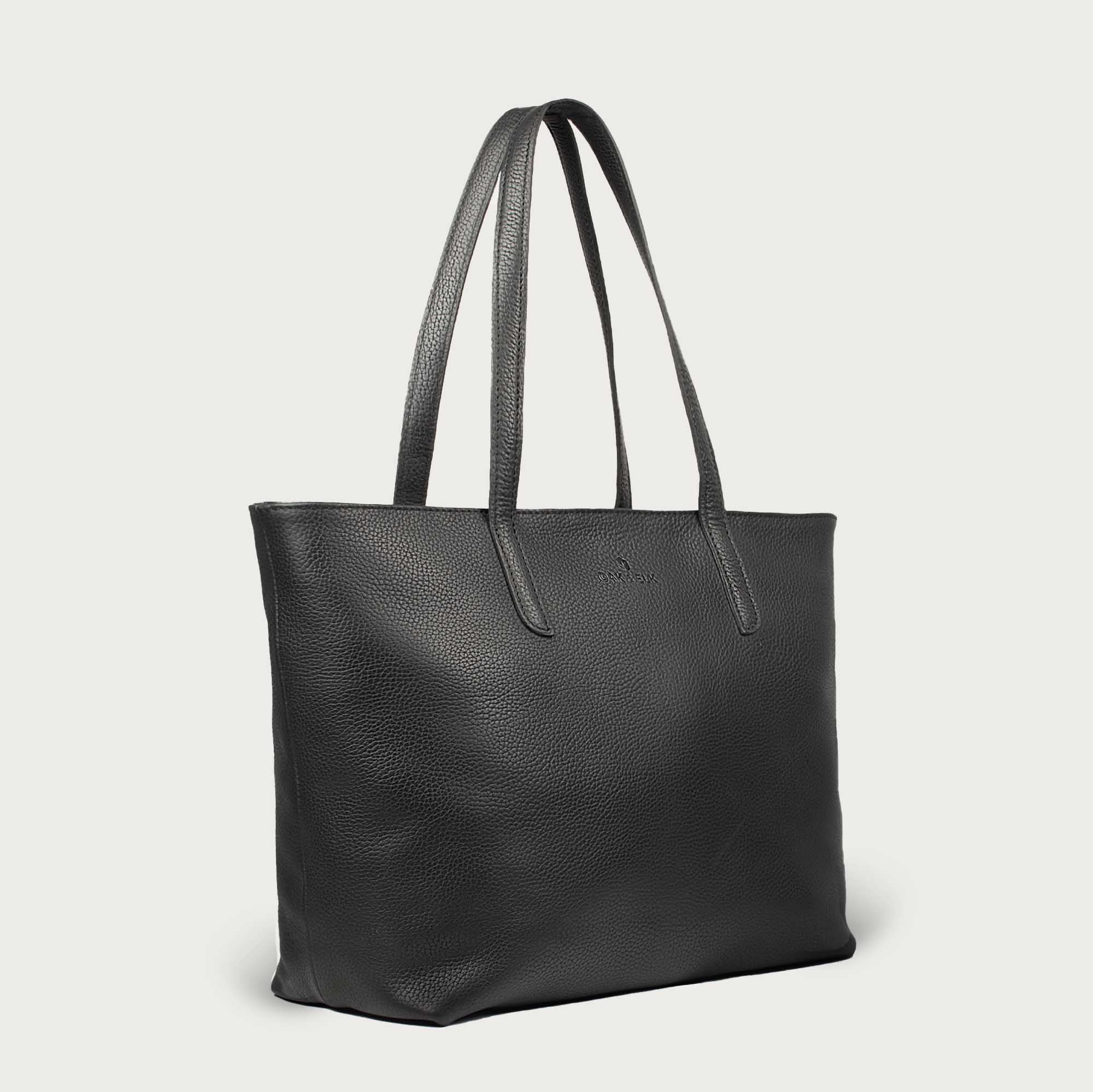 Leather tote made from top-grain leather, featuring smooth golden zipper, inner pouch, and structured design for daily use.