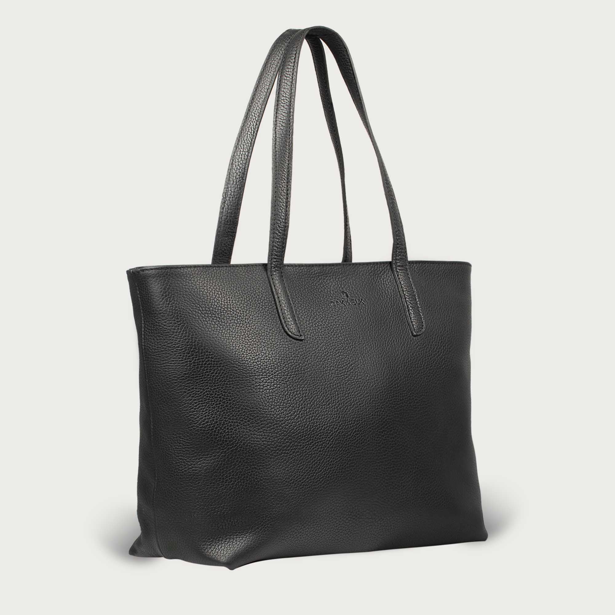 Leather tote made from top-grain leather, featuring smooth golden zipper, inner pouch, and structured design for daily use.