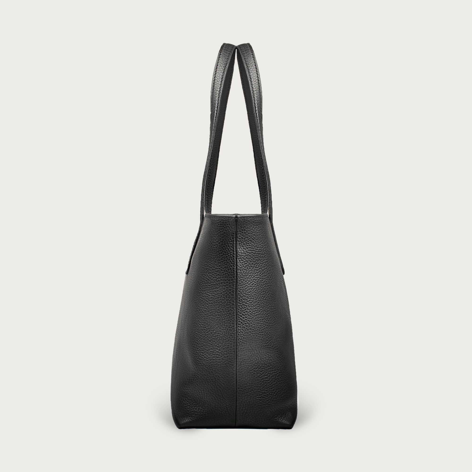 Leather tote made from top-grain leather, featuring smooth golden zipper, inner pouch, and structured design for daily use.
