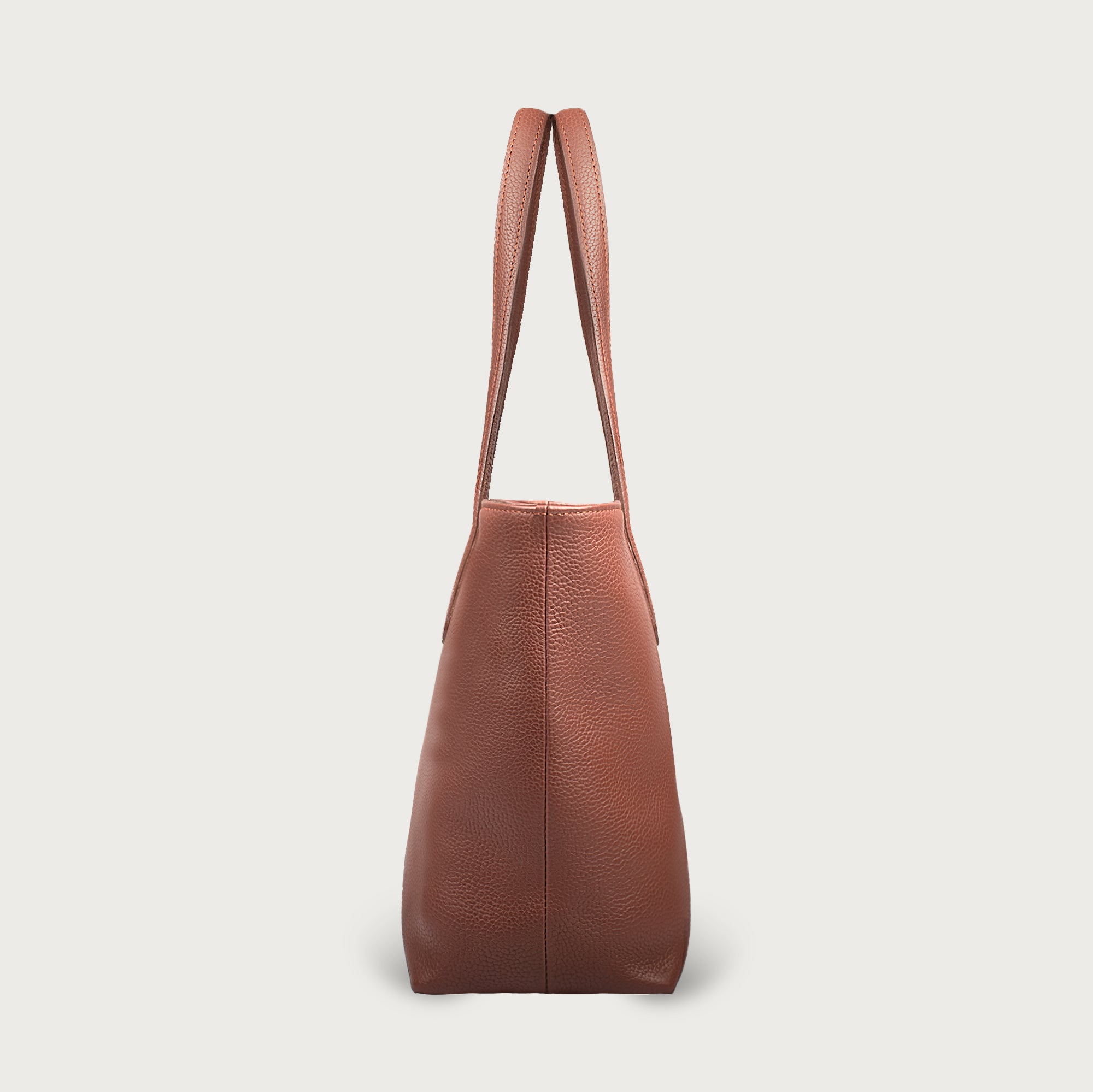Leather tote made from top-grain leather, featuring smooth golden zipper, inner pouch, and structured design for daily use.