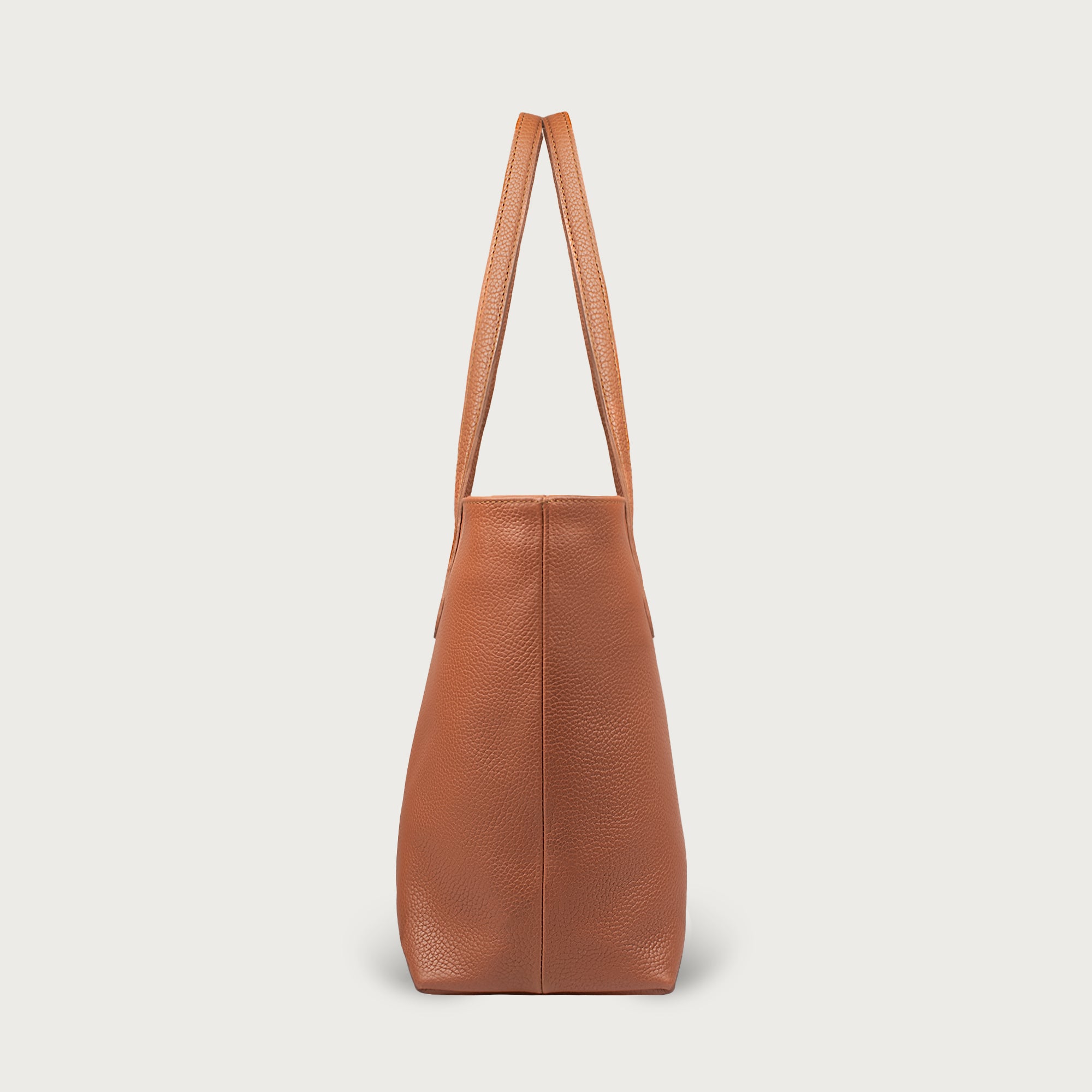 Leather tote made from top-grain leather, featuring smooth golden zipper, inner pouch, and structured design for daily use.