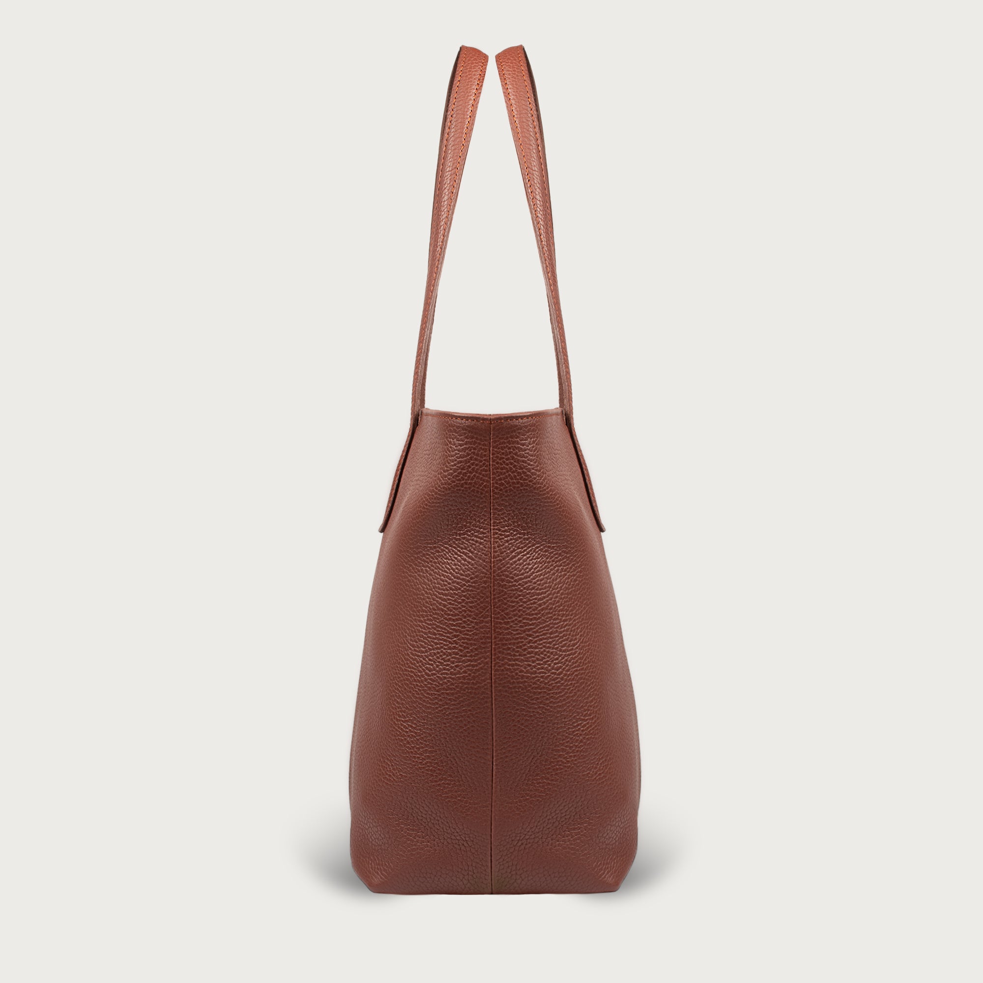 Leather tote made from top-grain leather, featuring smooth golden zipper, inner pouch, and structured design for daily use.
