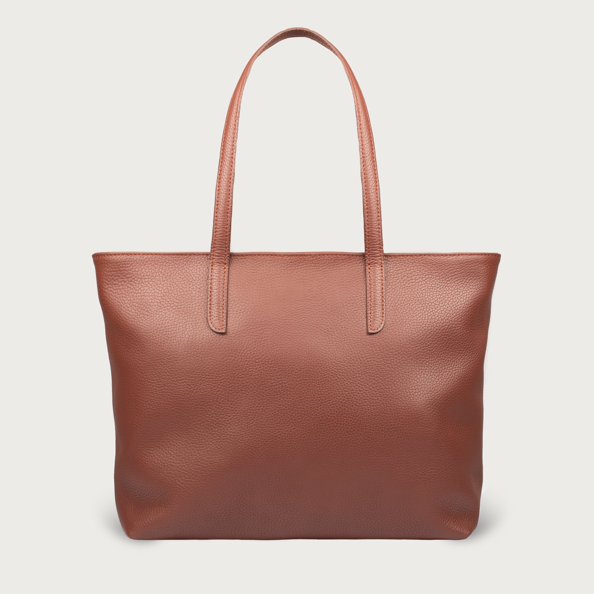 Leather tote made from top-grain leather, featuring smooth golden zipper, inner pouch, and structured design for daily use.