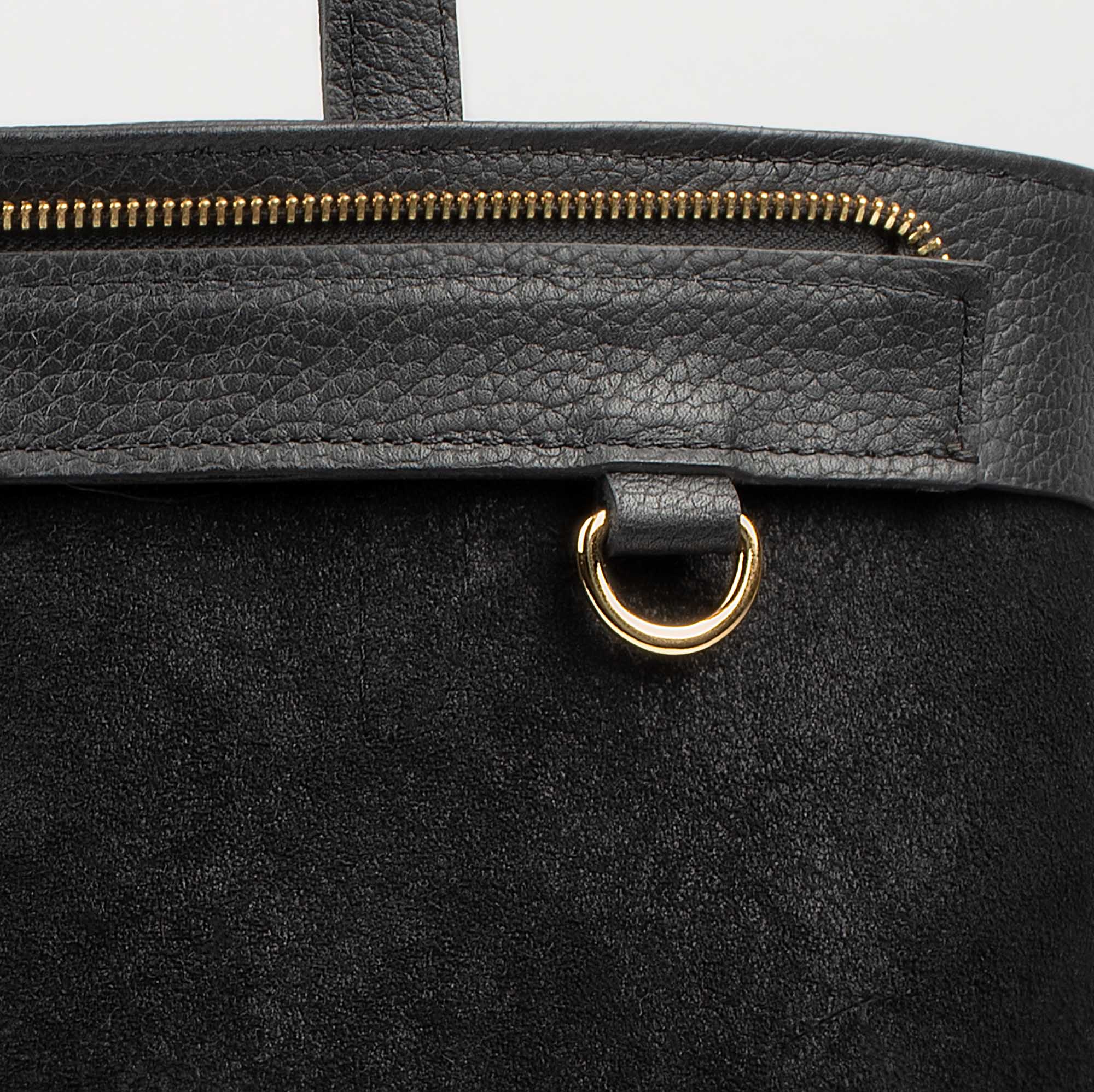 Leather tote made from top-grain leather, featuring smooth golden zipper, inner pouch, and structured design for daily use.