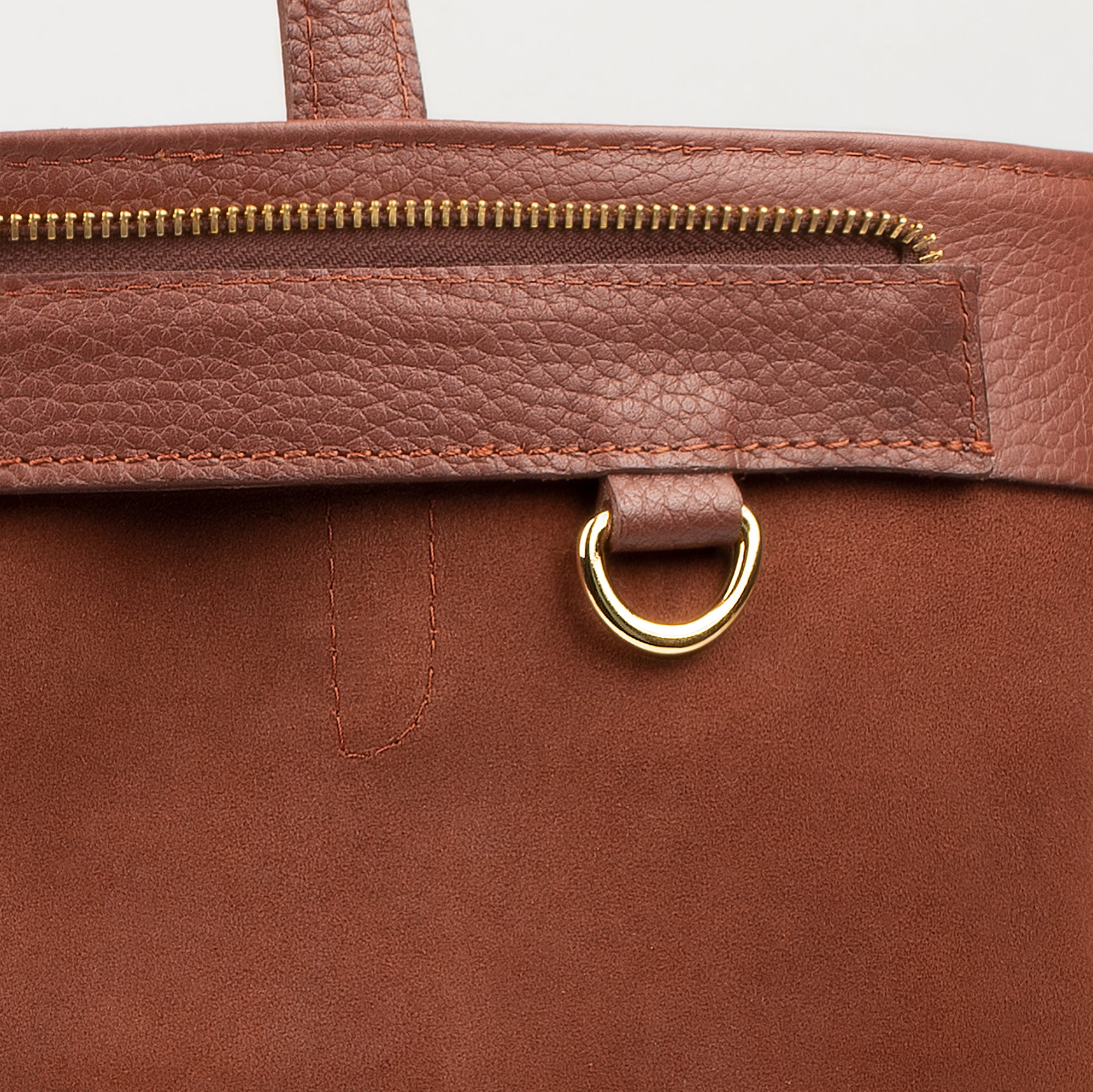 Leather tote made from top-grain leather, featuring smooth golden zipper, inner pouch, and structured design for daily use.