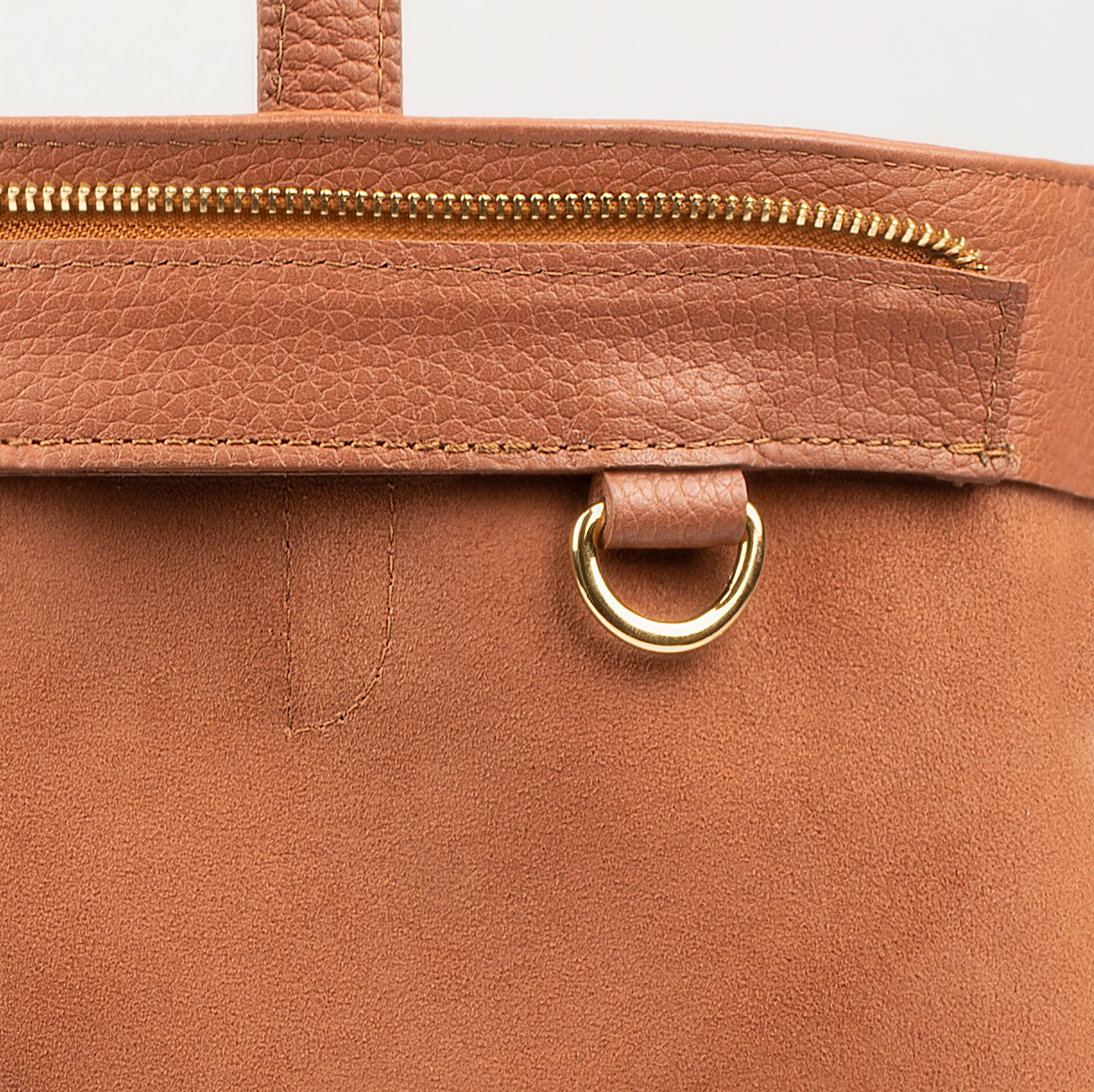 Leather tote made from top-grain leather, featuring smooth golden zipper, inner pouch, and structured design for daily use.