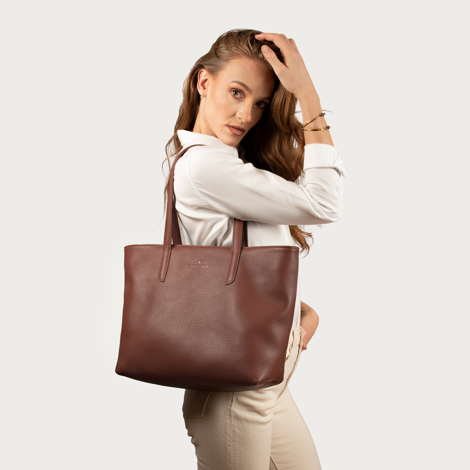 Leather tote made from top-grain leather, featuring smooth golden zipper, inner pouch, and structured design for daily use.