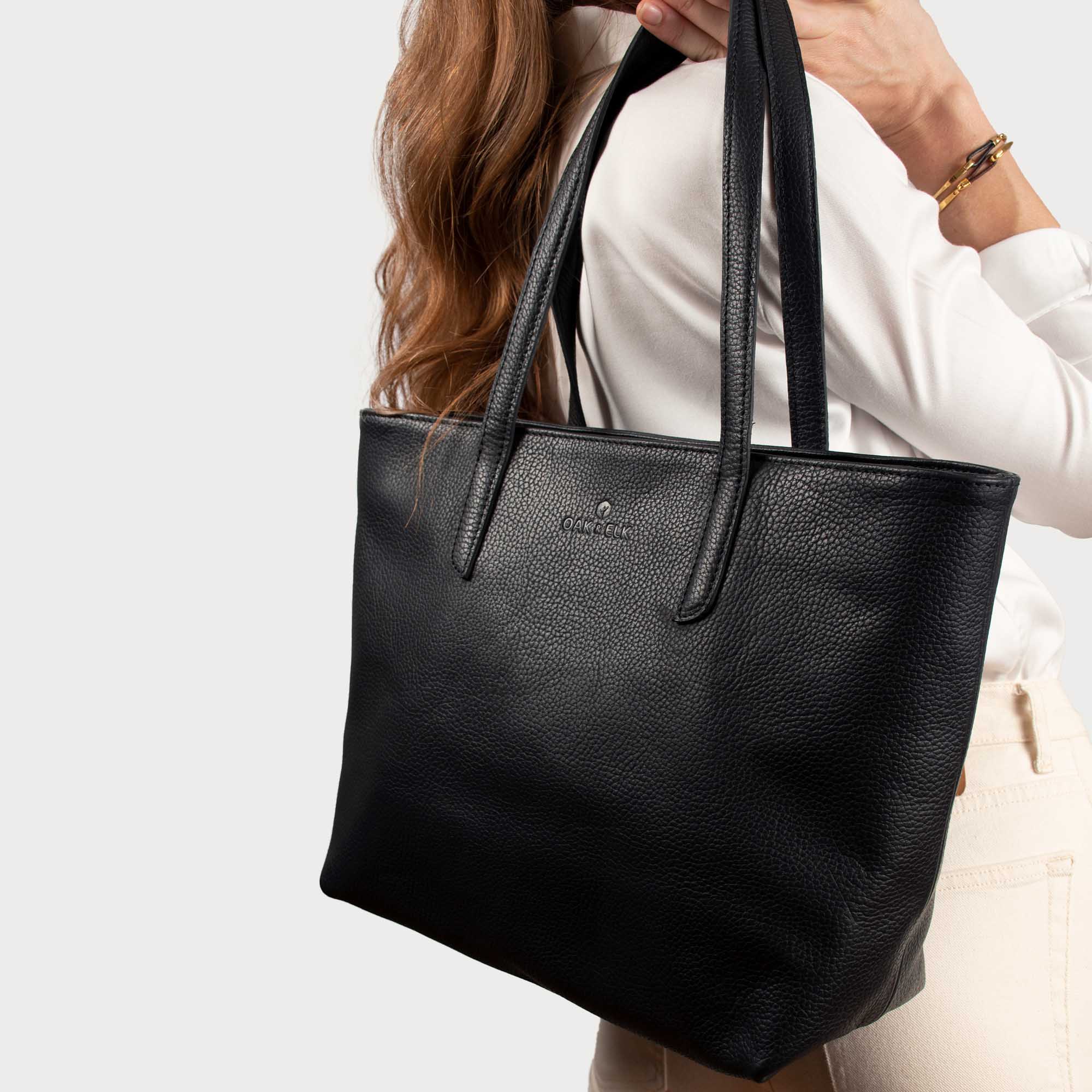 Leather tote made from top-grain leather, featuring smooth golden zipper, inner pouch, and structured design for daily use.
