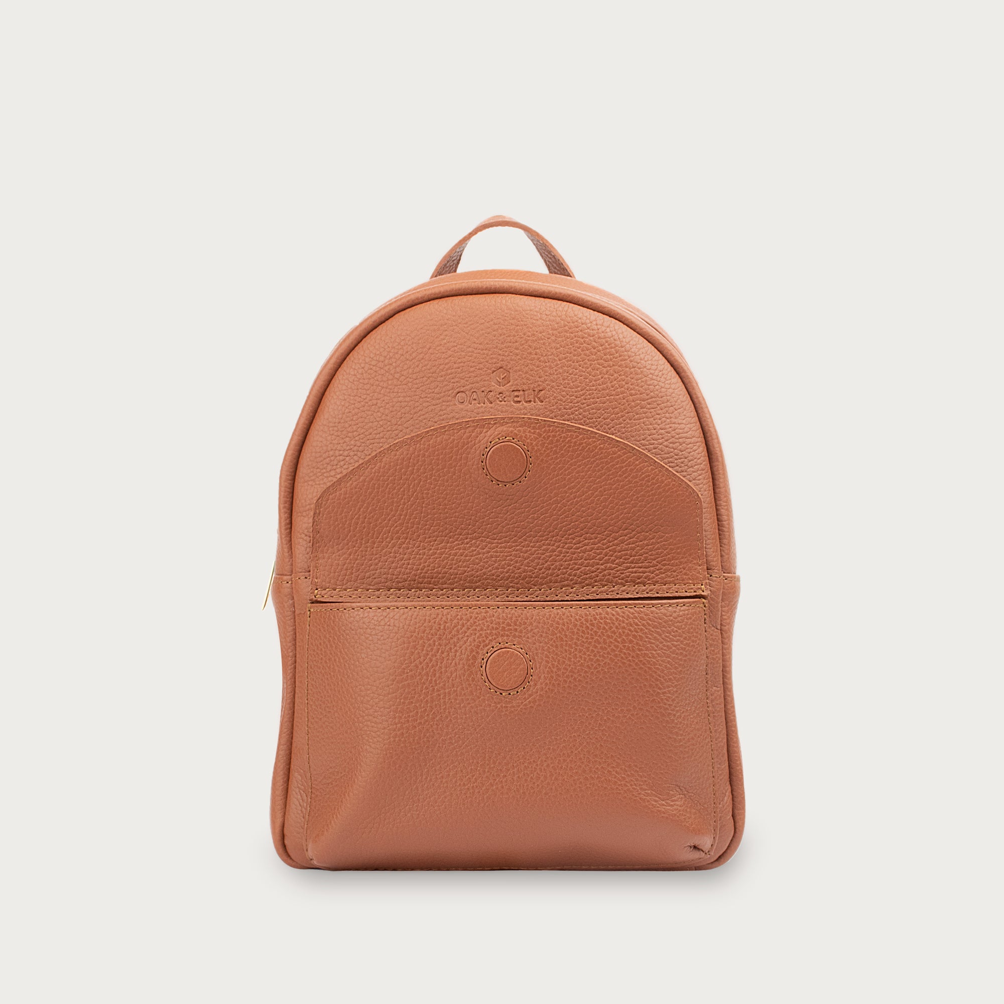 Leather backpack with smooth finish, adjustable straps, front zipper pocket, and gold hardware – Emma by OAK & ELK.