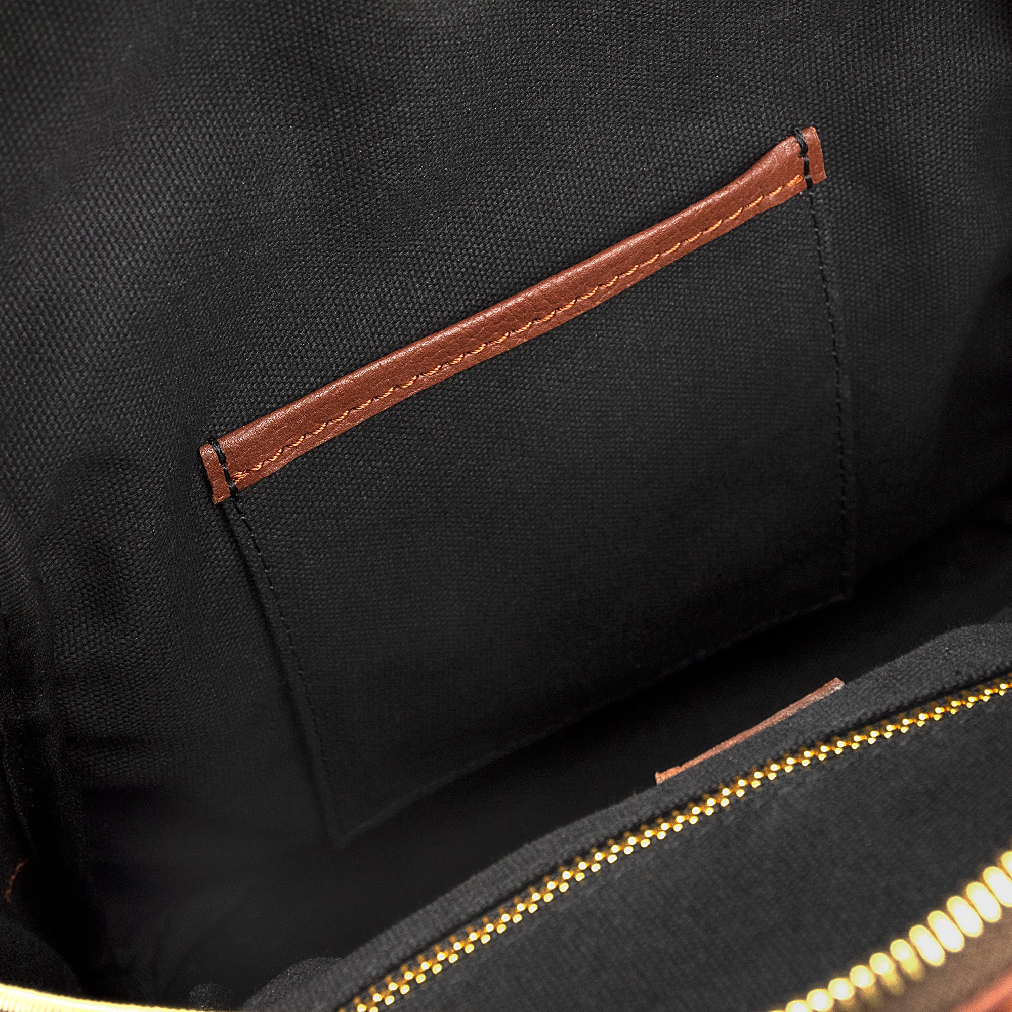 Leather backpack with smooth finish, adjustable straps, front zipper pocket, and gold hardware – Emma by OAK & ELK.