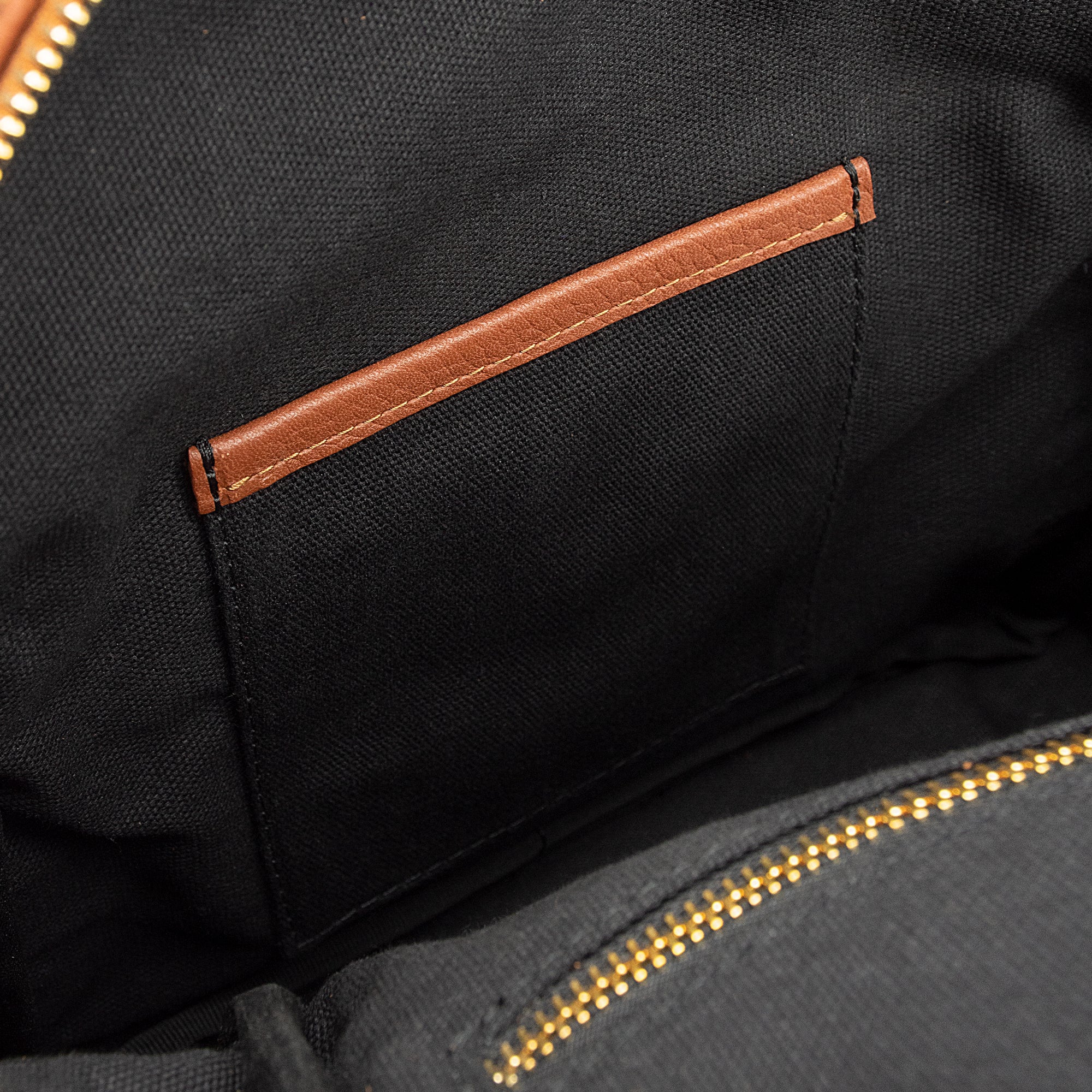 Leather backpack with smooth finish, adjustable straps, front zipper pocket, and gold hardware – Emma by OAK & ELK.