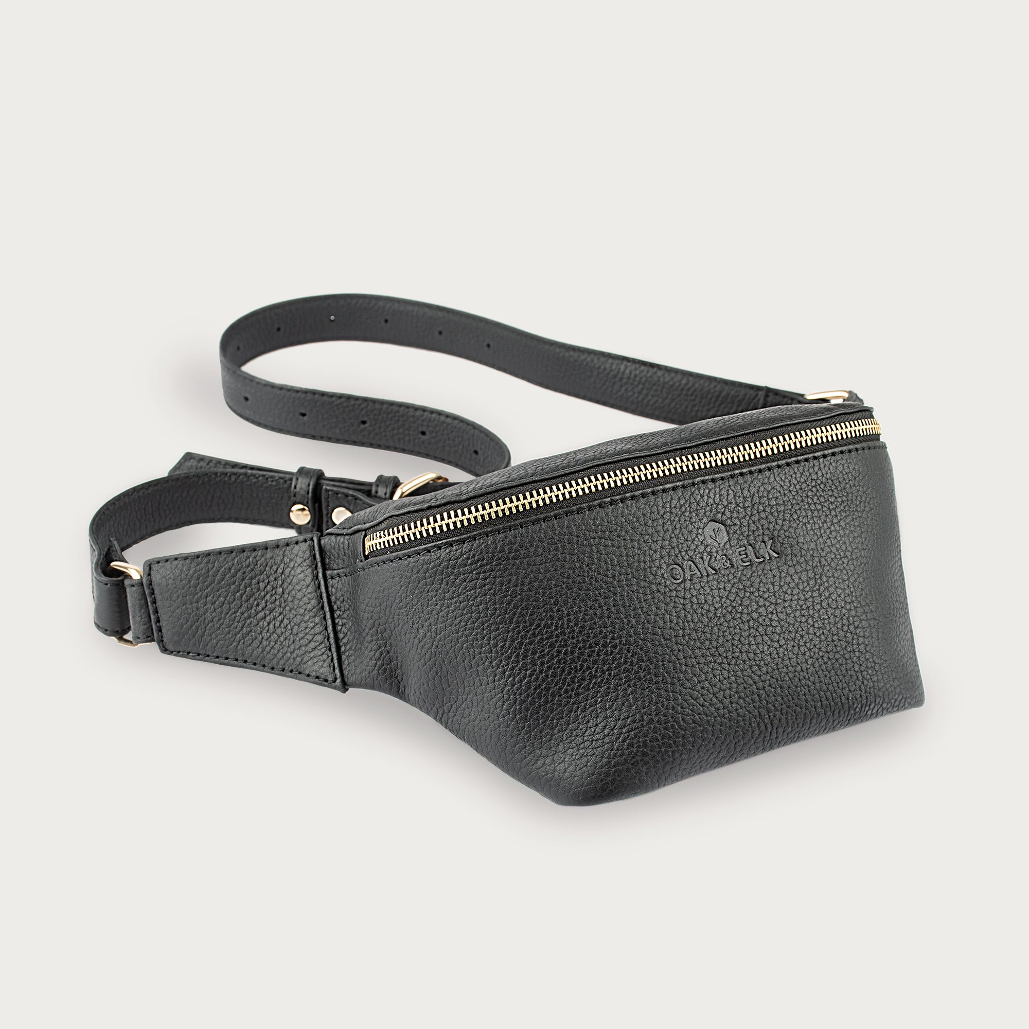 Black leather fanny pack with multiple compartments, zipper pockets, and adjustable strap — sleek and practical for daily use