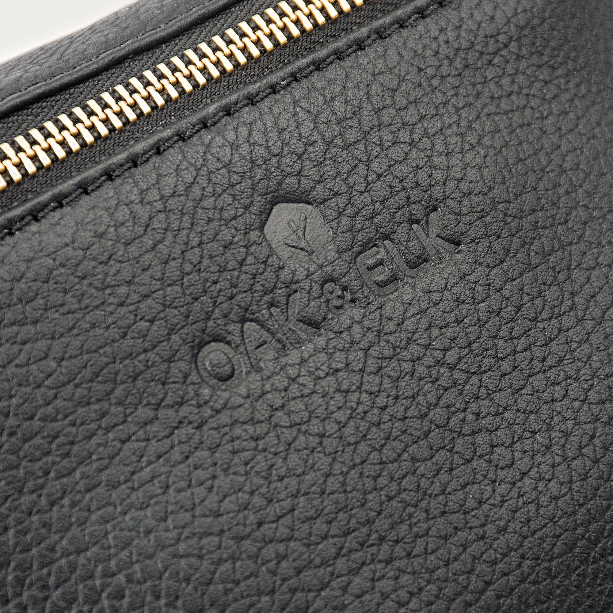 Black leather fanny pack with multiple compartments, zipper pockets, and adjustable strap — sleek and practical for daily use