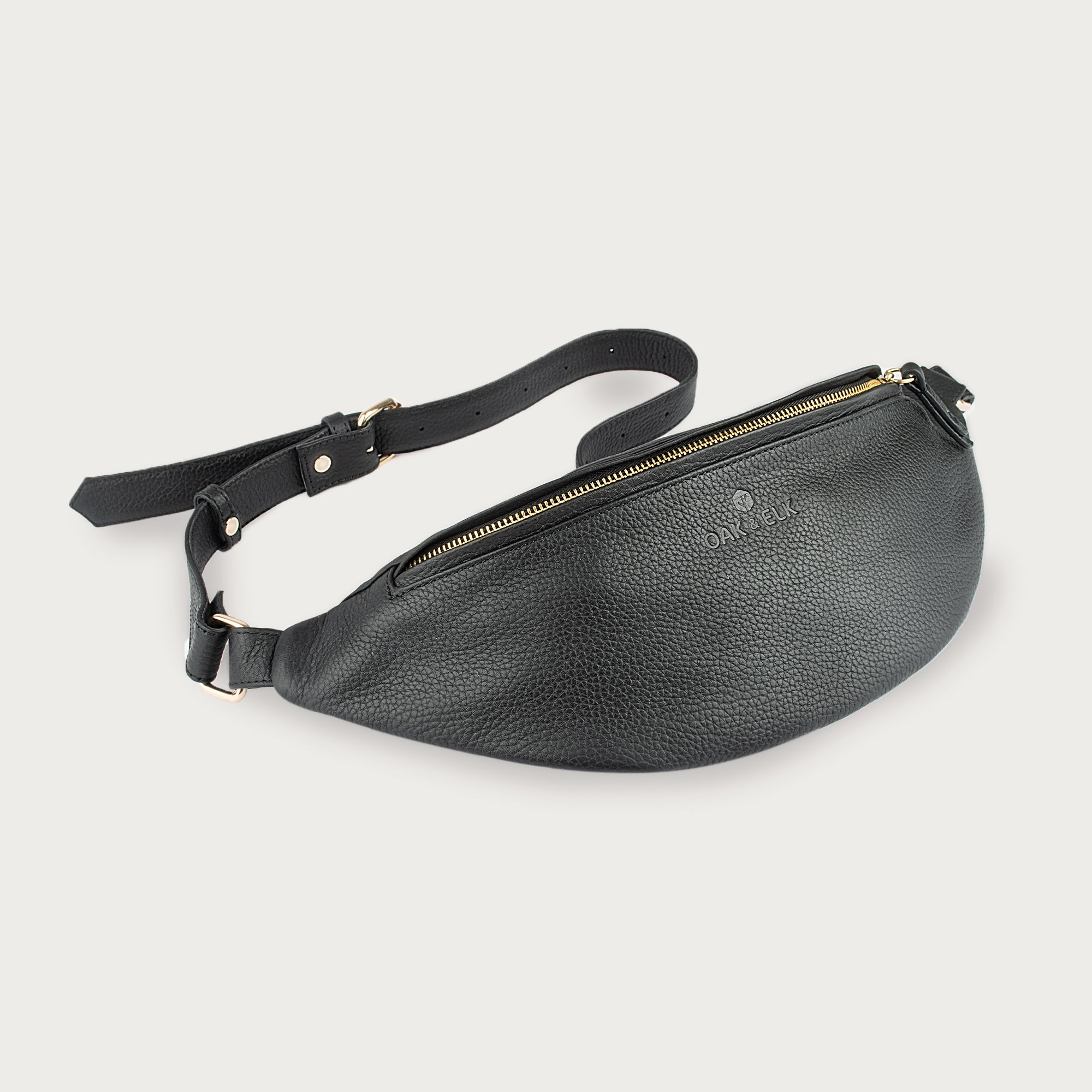 Large black leather fanny pack with multiple compartments, zipper pockets, adjustable strap — sleek practical for daily use