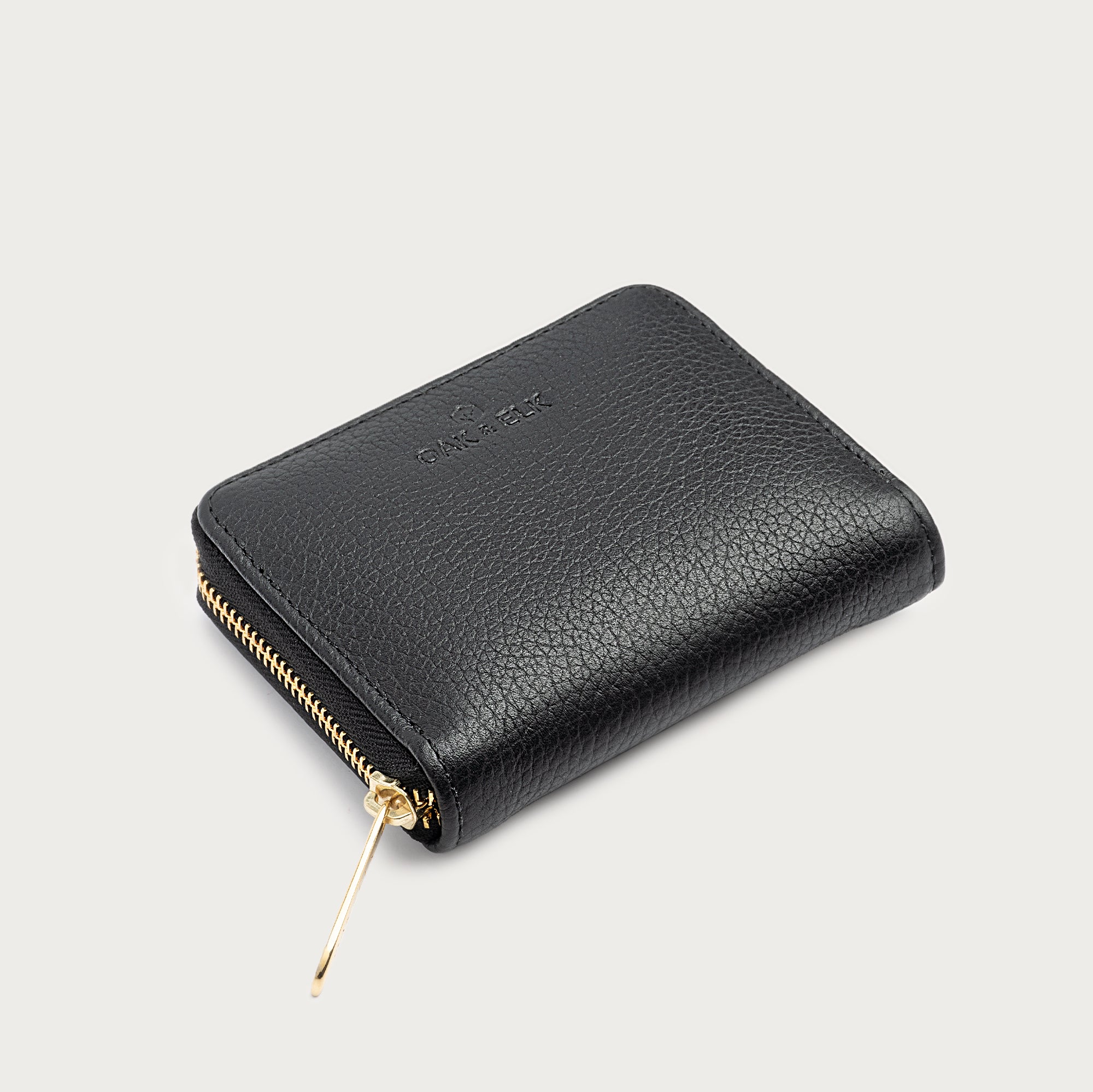 Compact leather wallet with zipper closure and card slots — perfect for essentials and everyday carry.