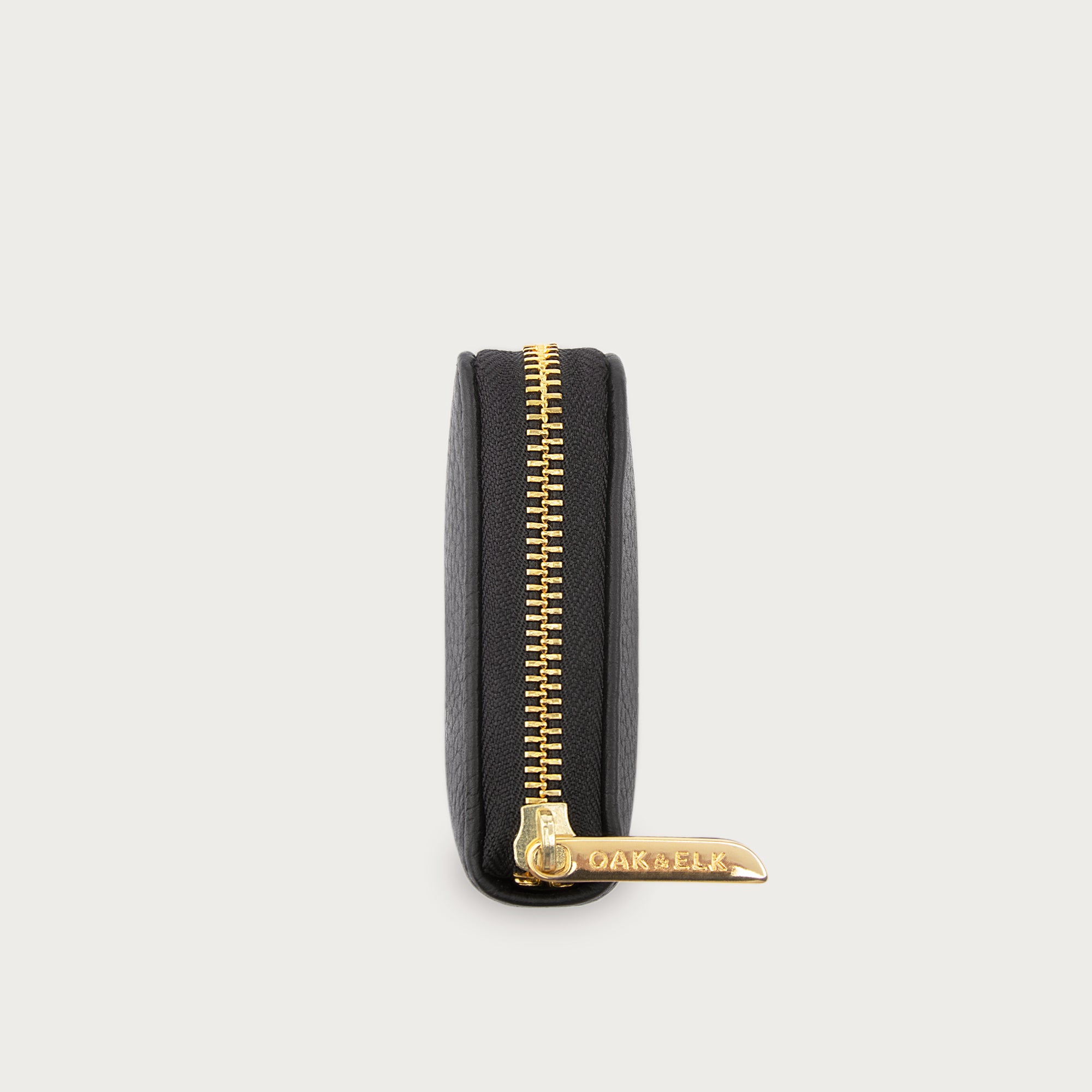 Compact leather wallet with zipper closure and card slots — perfect for essentials and everyday carry.