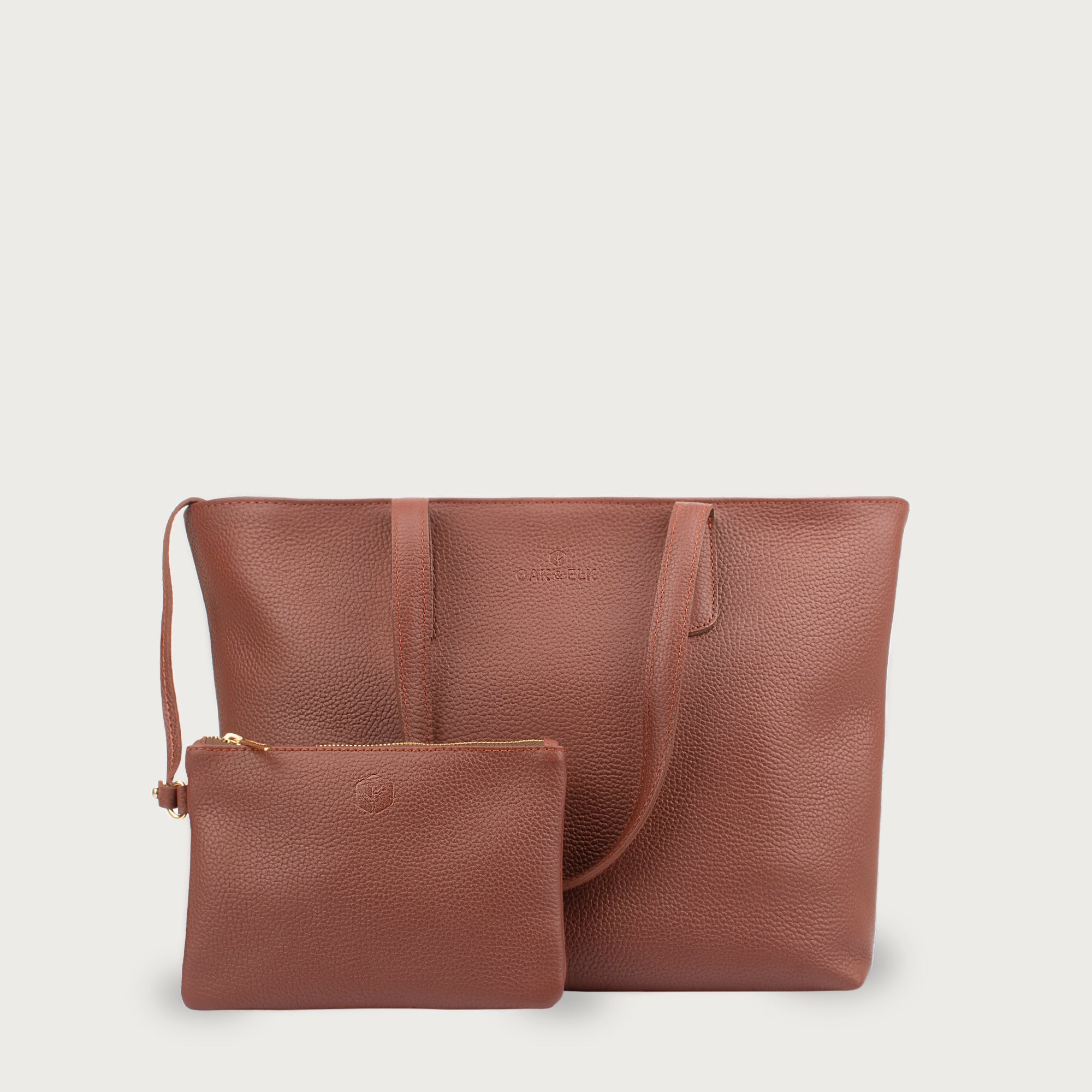 Leather tote made from top-grain leather, featuring smooth golden zipper, inner pouch, and structured design for daily use.