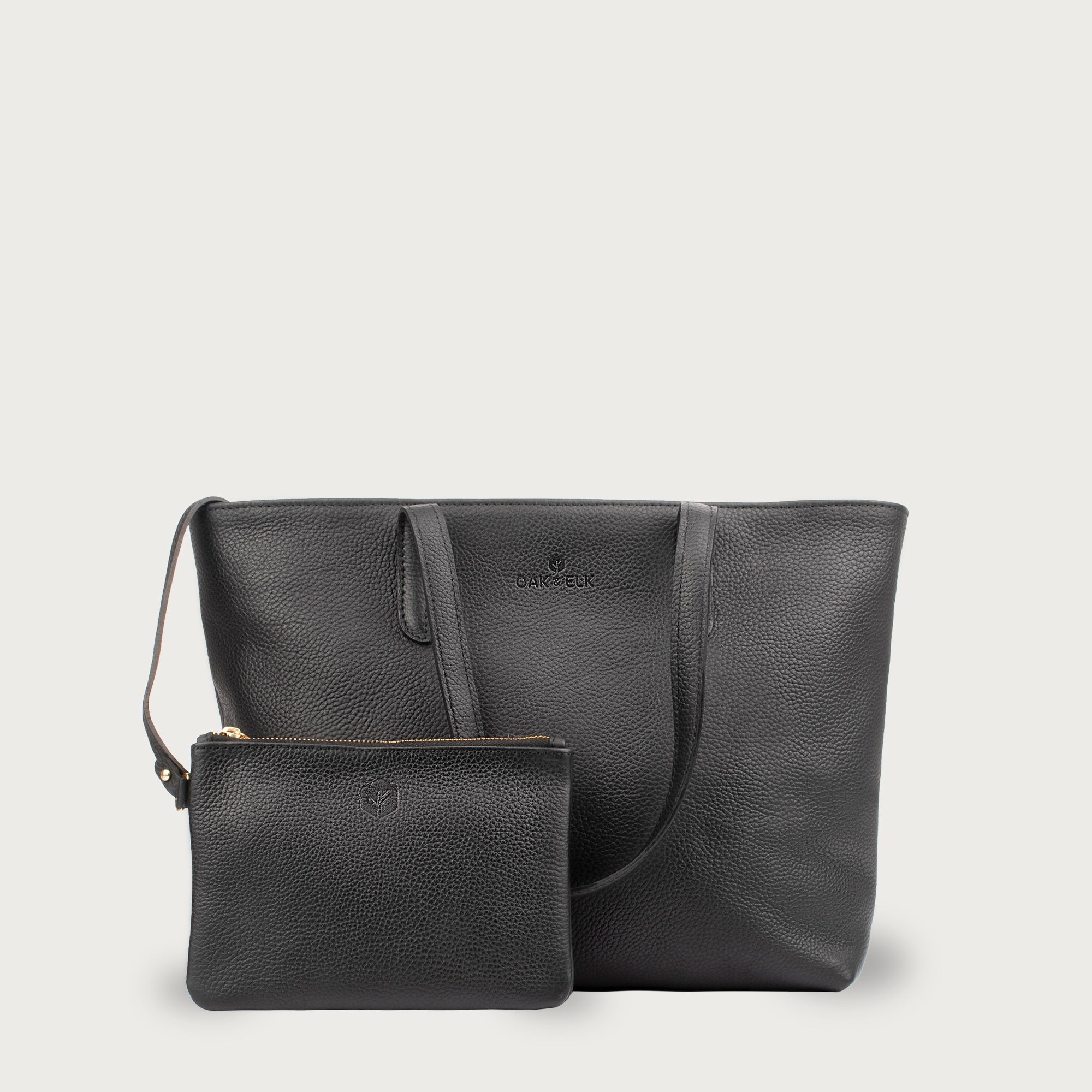 Leather tote made from top-grain leather, featuring smooth golden zipper, inner pouch, and structured design for daily use.