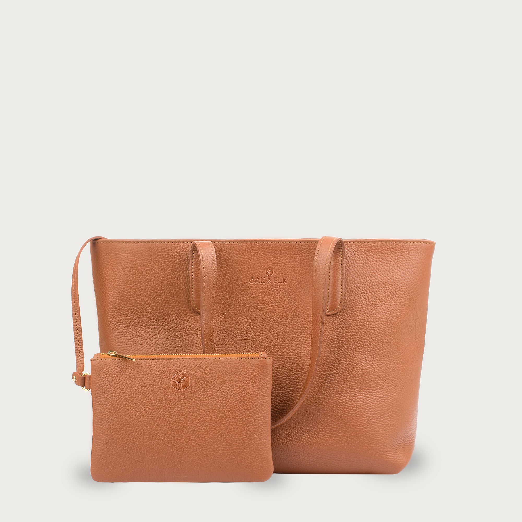 Leather tote made from top-grain leather, featuring smooth golden zipper, inner pouch, and structured design for daily use.