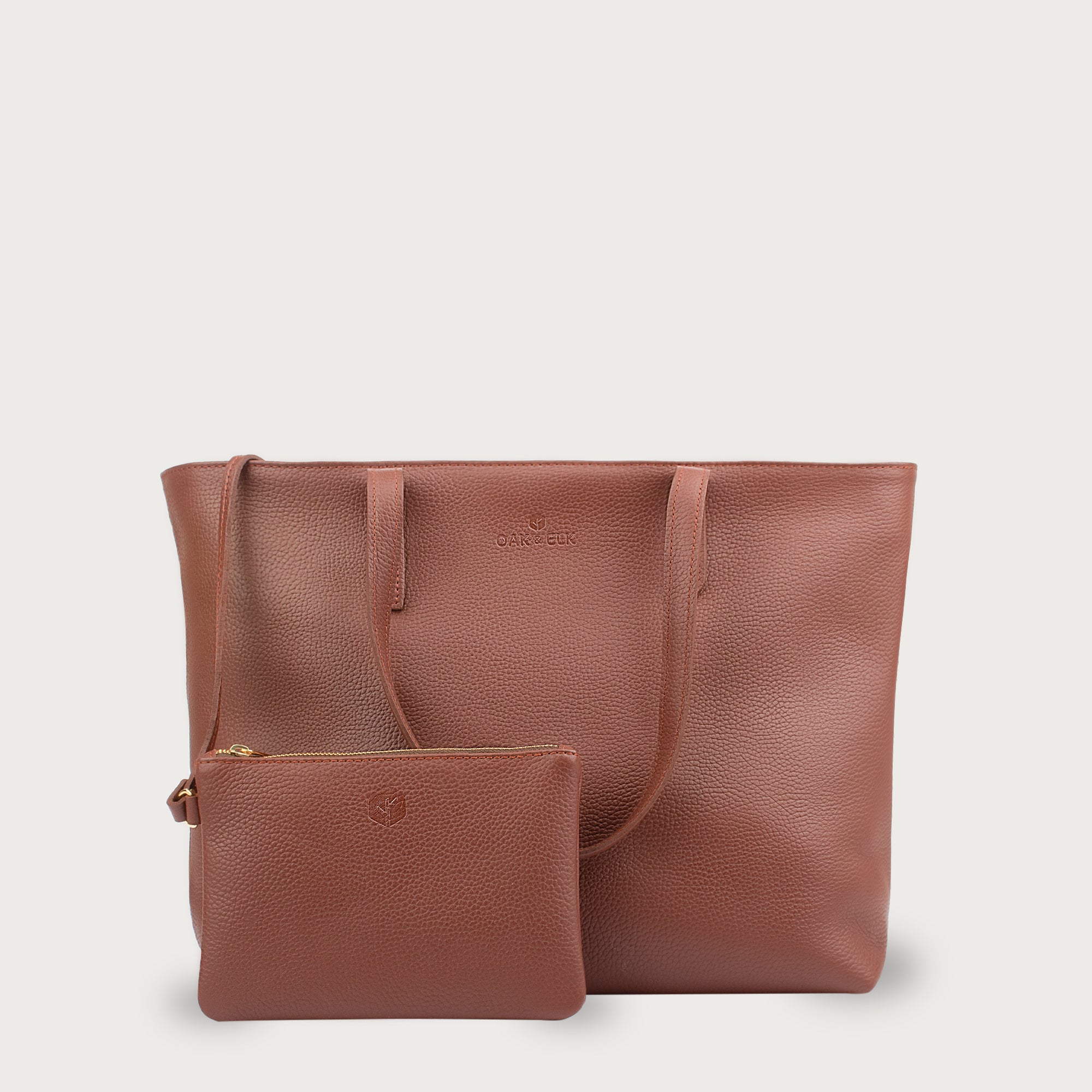 Leather tote made from top-grain leather, featuring smooth golden zipper, inner pouch, and structured design for daily use.