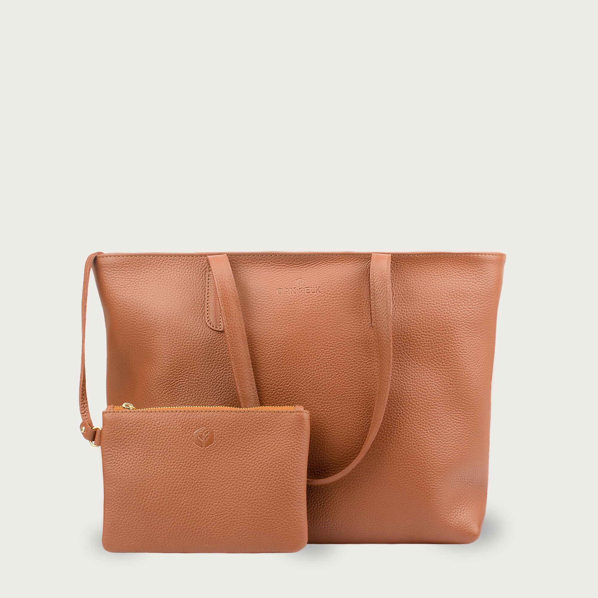 Leather tote made from top-grain leather, featuring smooth golden zipper, inner pouch, and structured design for daily use.