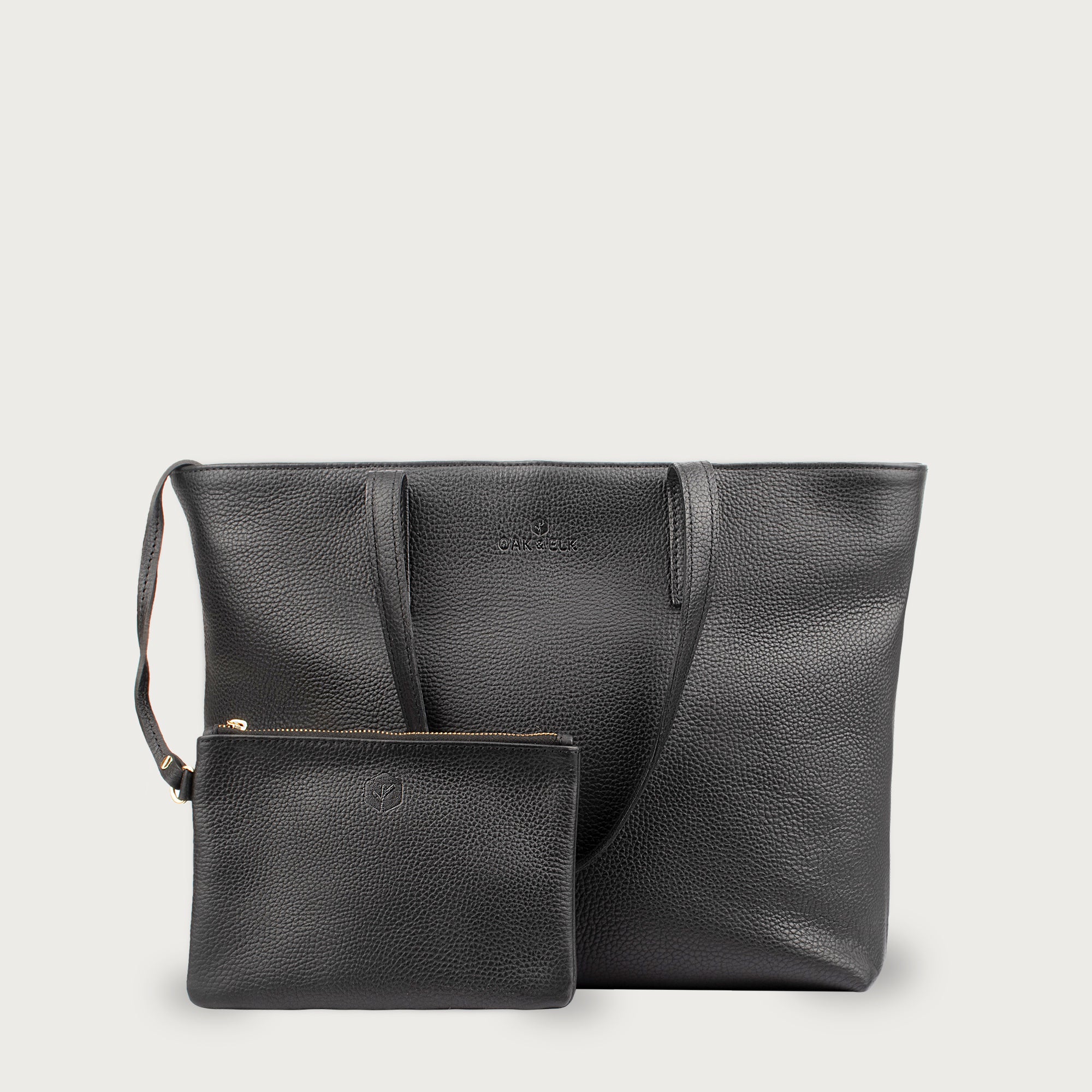 Leather tote made from top-grain leather, featuring smooth golden zipper, inner pouch, and structured design for daily use.