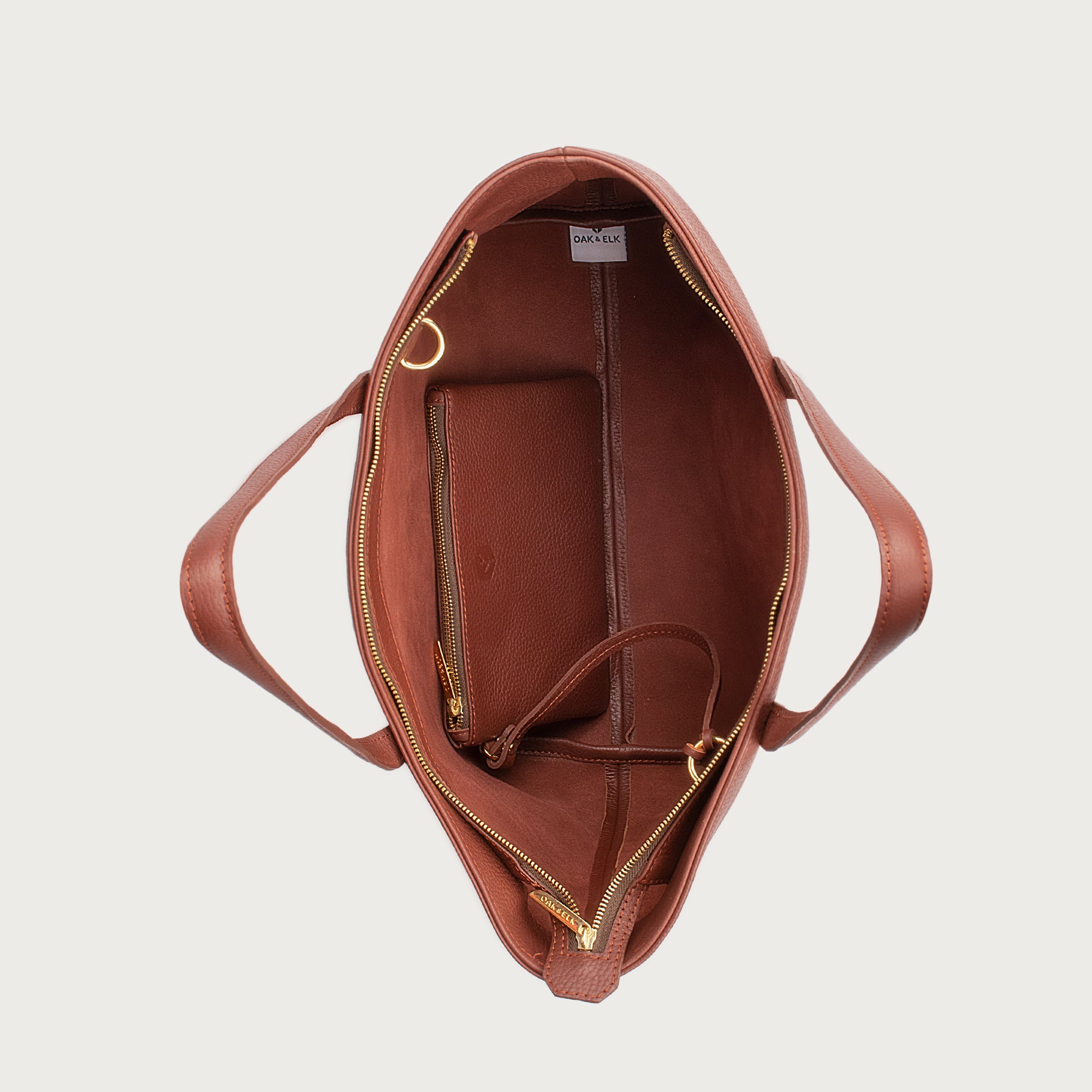 Leather tote made from top-grain leather, featuring smooth golden zipper, inner pouch, and structured design for daily use.