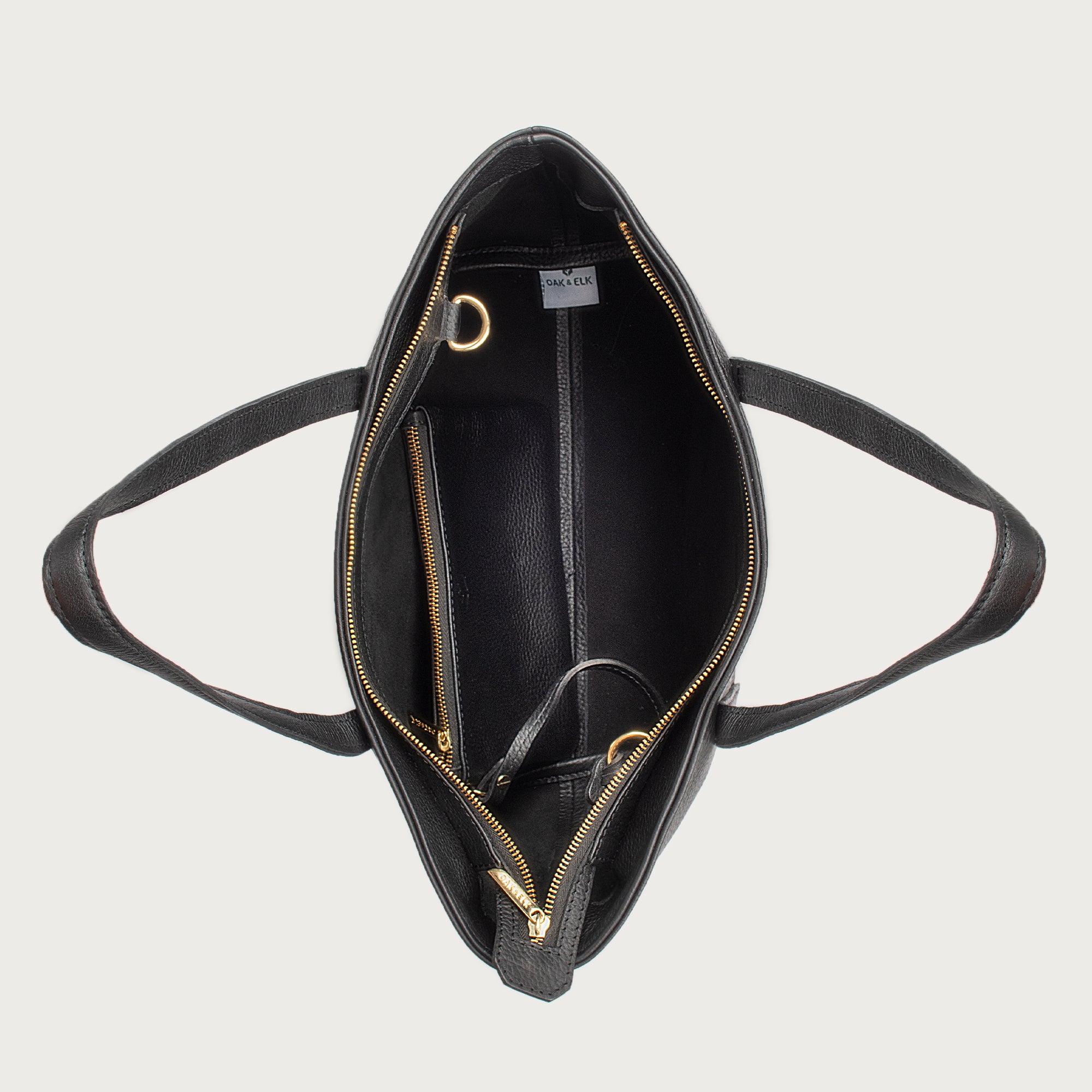 Leather tote made from top-grain leather, featuring smooth golden zipper, inner pouch, and structured design for daily use.