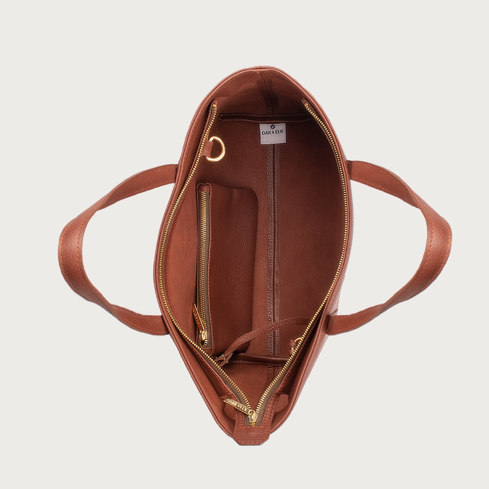 Leather tote made from top-grain leather, featuring smooth golden zipper, inner pouch, and structured design for daily use.