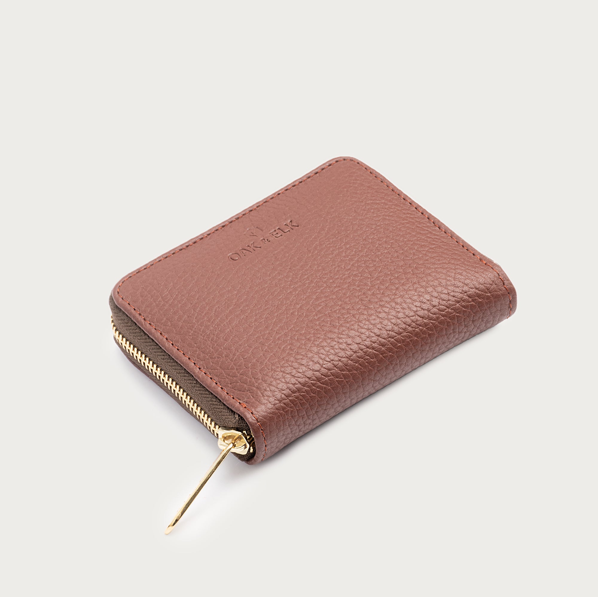 Compact leather wallet with zipper closure and card slots — perfect for essentials and everyday carry.
