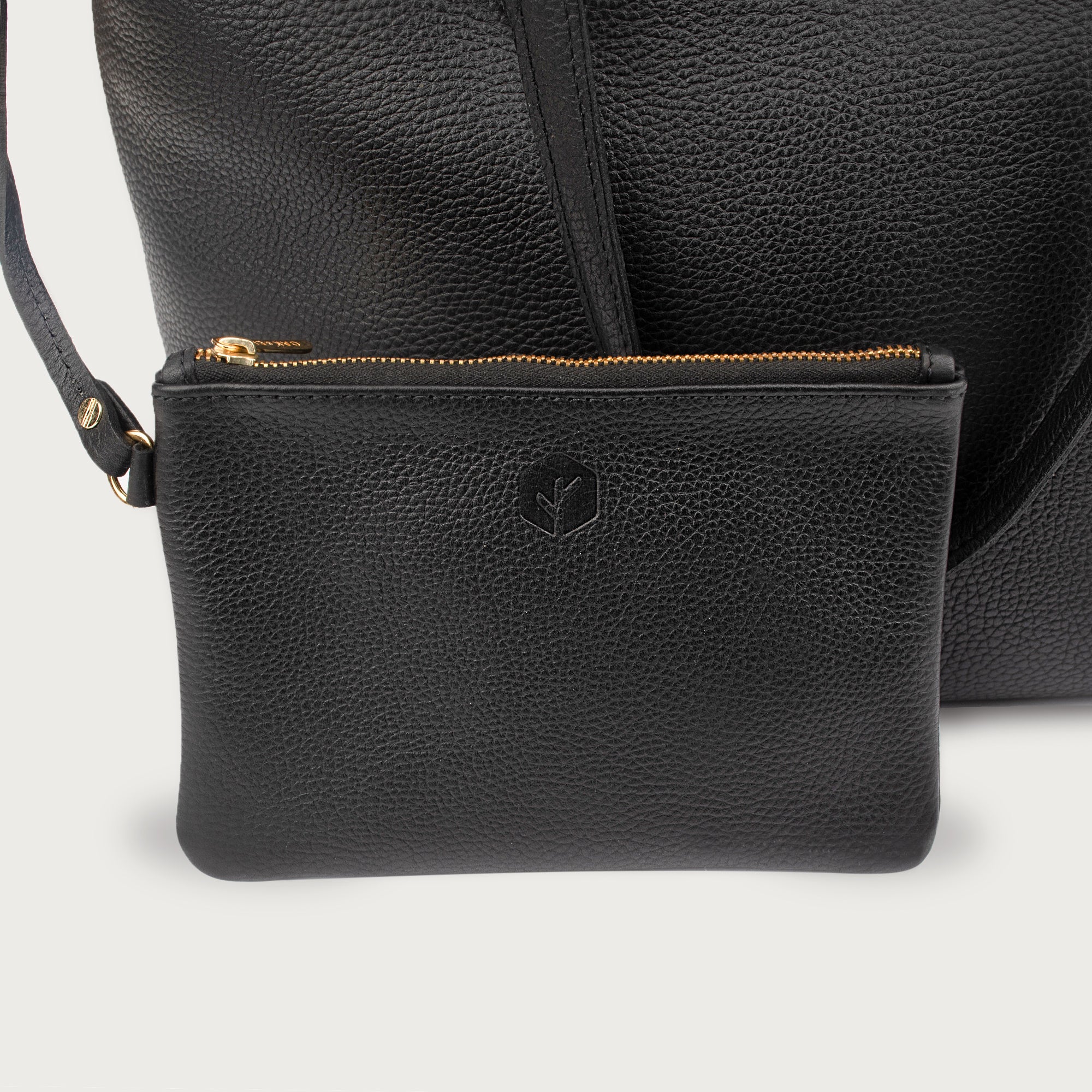 Leather tote made from top-grain leather, featuring smooth golden zipper, inner pouch, and structured design for daily use.