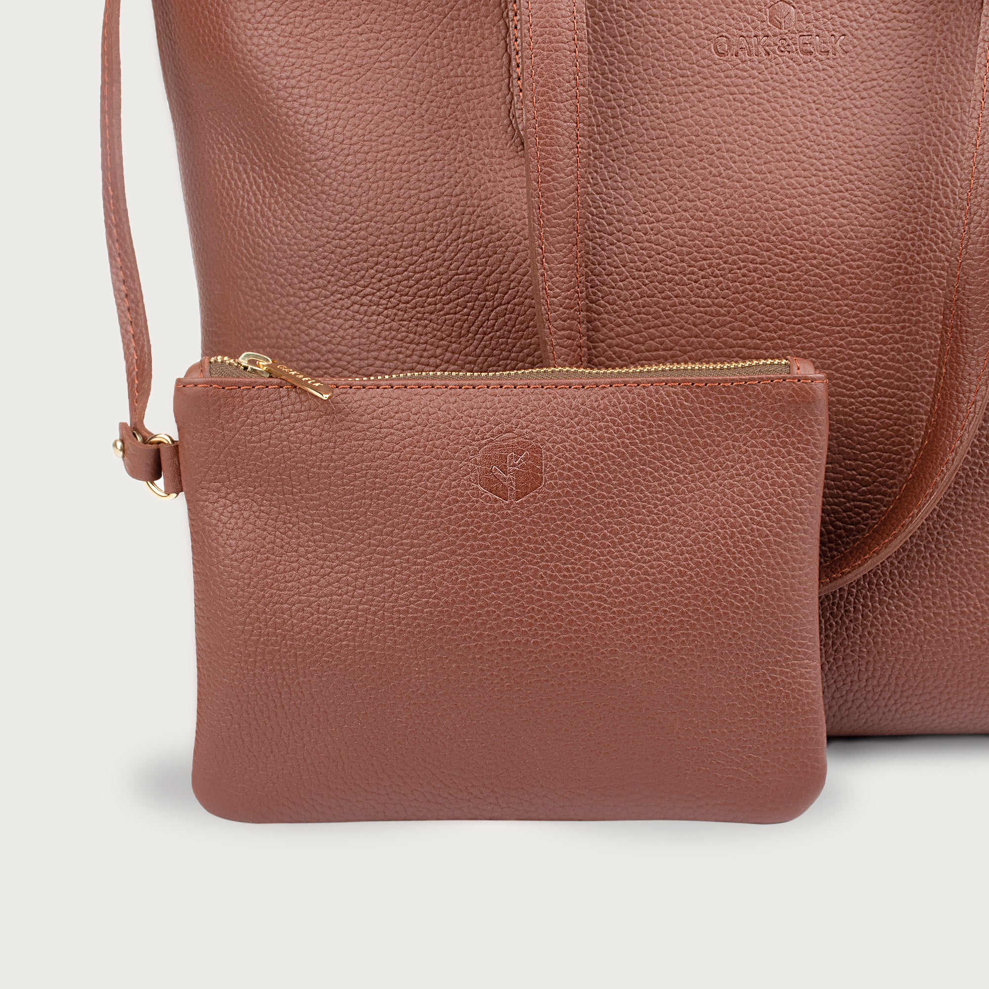 Leather tote made from top-grain leather, featuring smooth golden zipper, inner pouch, and structured design for daily use.