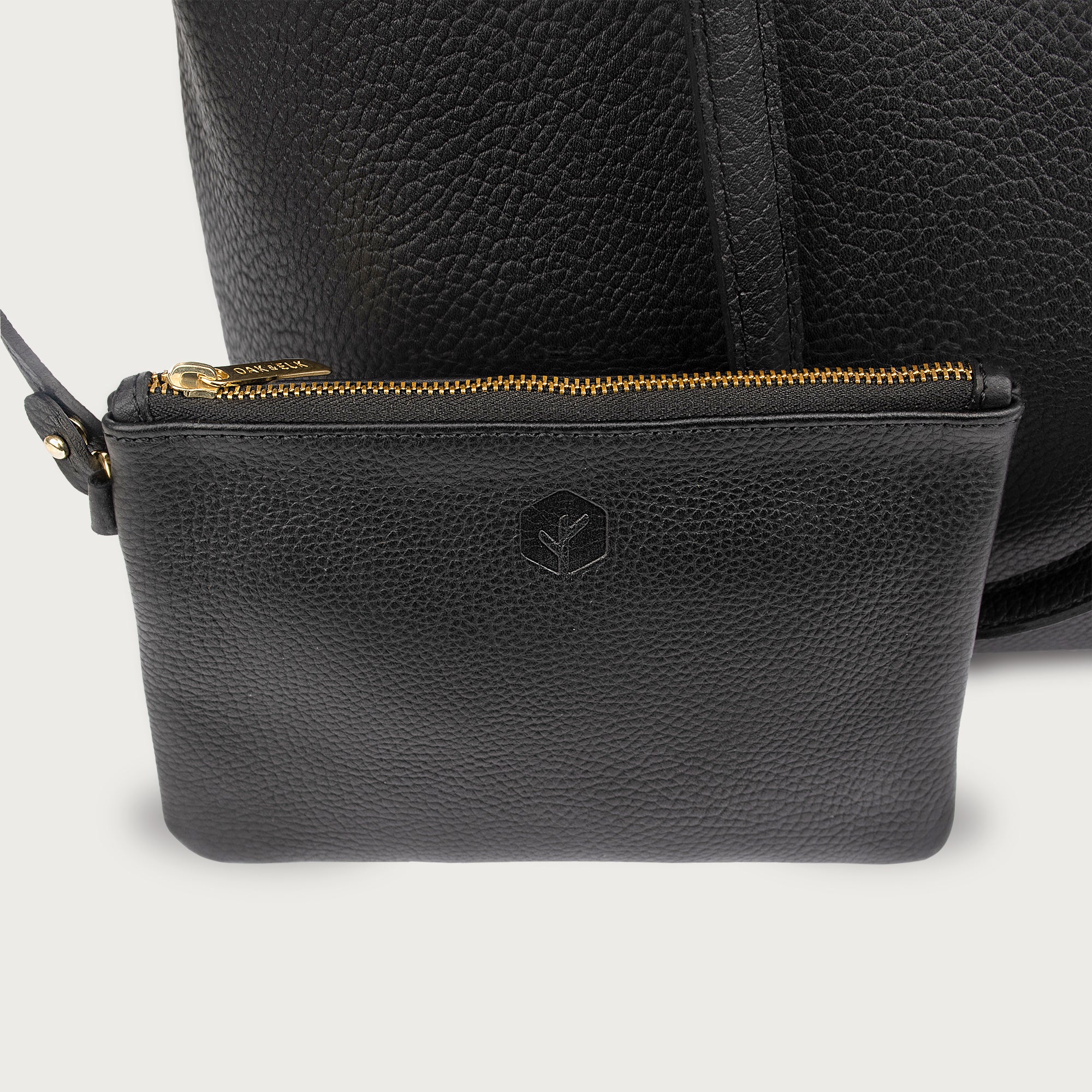 Leather tote made from top-grain leather, featuring smooth golden zipper, inner pouch, and structured design for daily use.