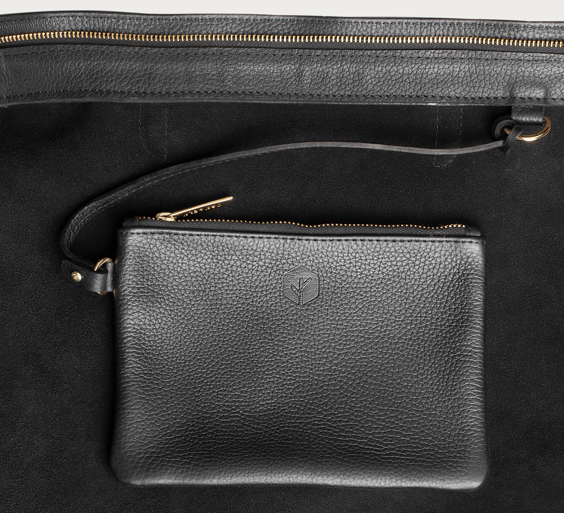 Leather tote made from top-grain leather, featuring smooth golden zipper, inner pouch, and structured design for daily use.