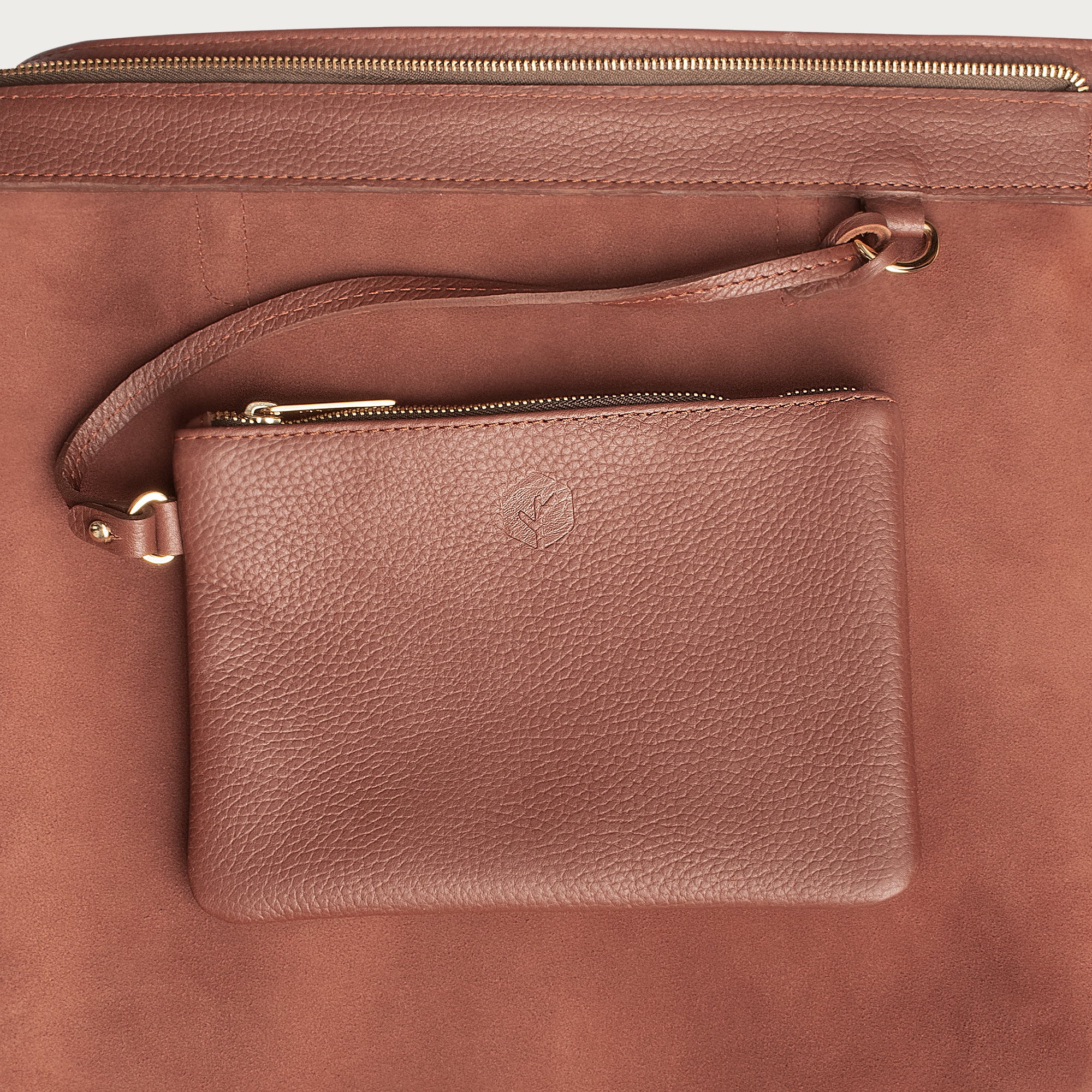 Leather tote made from top-grain leather, featuring smooth golden zipper, inner pouch, and structured design for daily use.