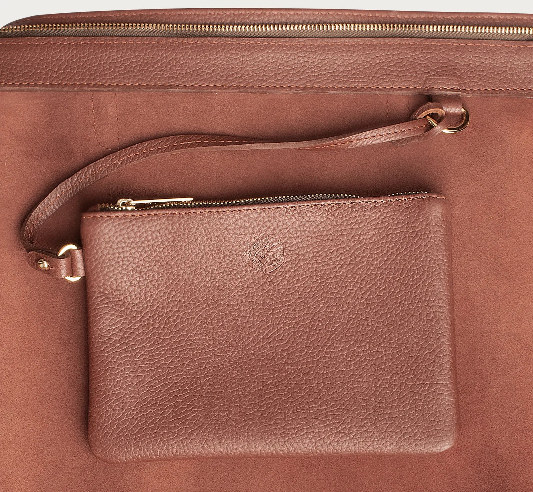 Leather tote made from top-grain leather, featuring smooth golden zipper, inner pouch, and structured design for daily use.