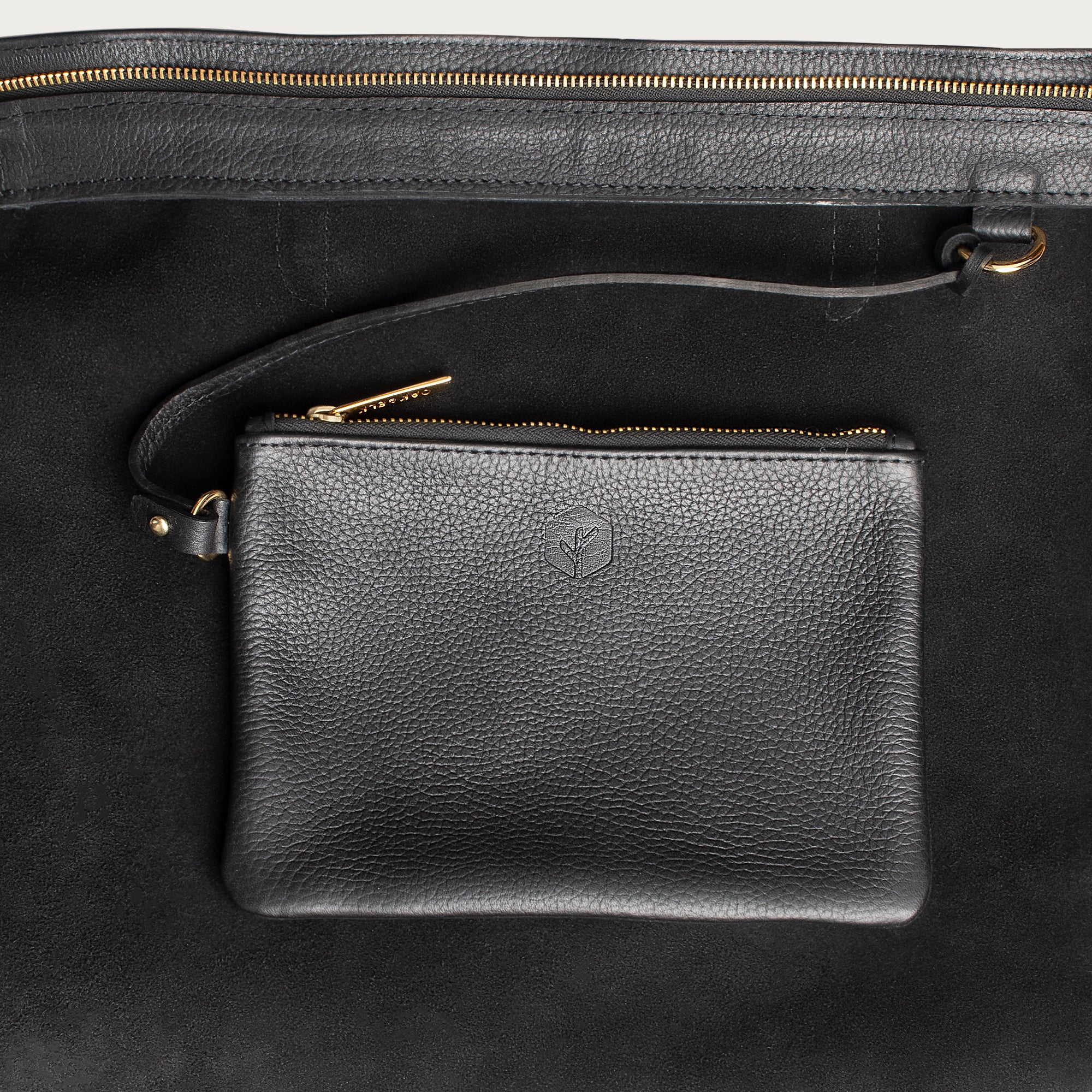 Leather tote made from top-grain leather, featuring smooth golden zipper, inner pouch, and structured design for daily use.