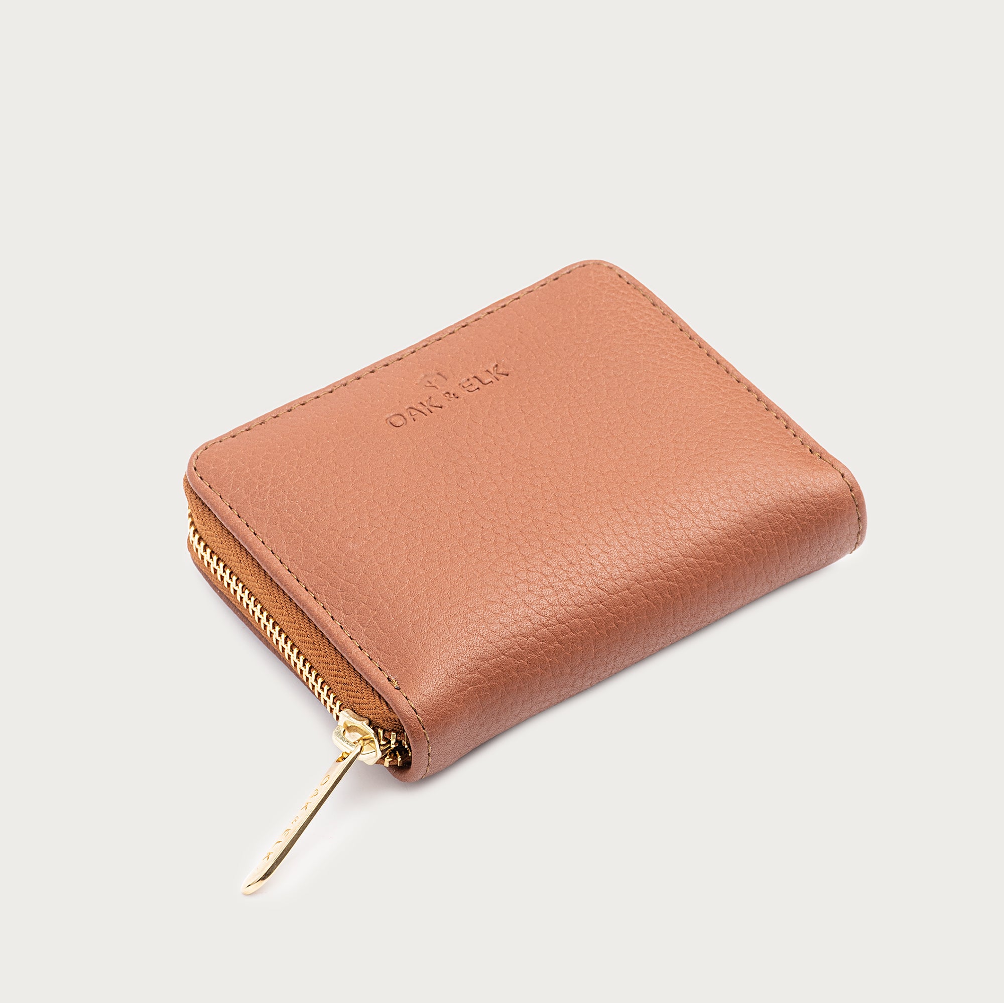 Compact leather wallet with zipper closure and card slots — perfect for essentials and everyday carry.