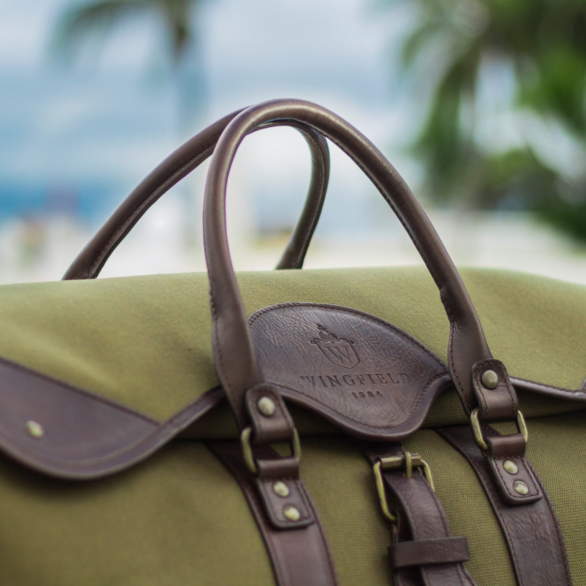 Wingfield canvas and leather duffel bag in olive green, an example of how parts of a cowhide are used in bags