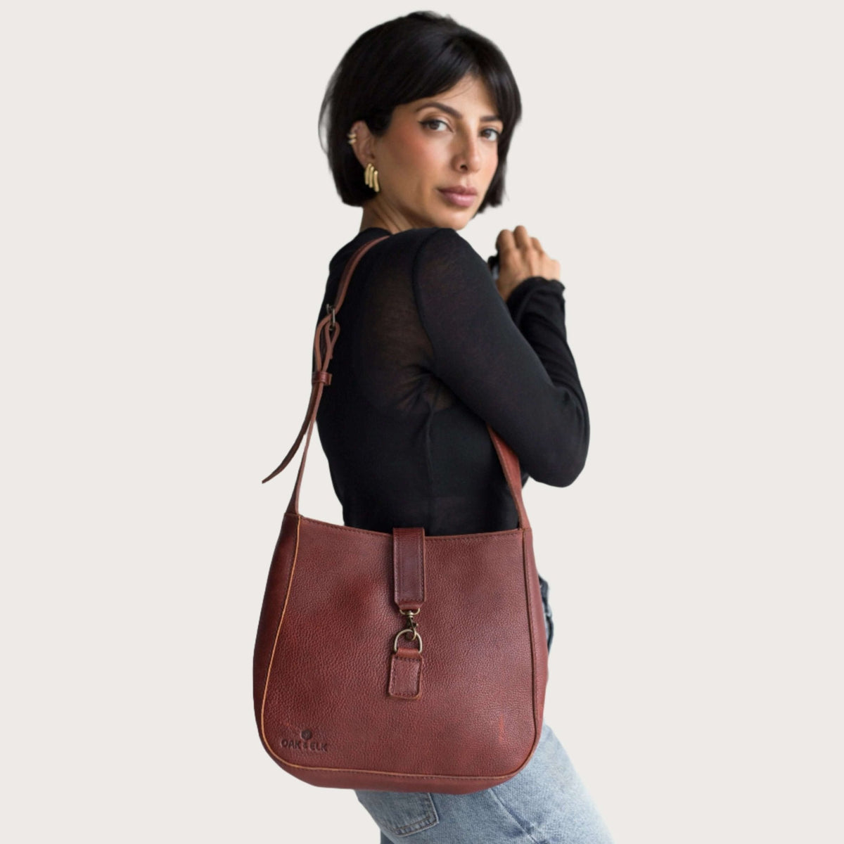 Full-grain leather shoulder bag in nutmeg, an example of quality leather compared to corrected-grain and bonded leather