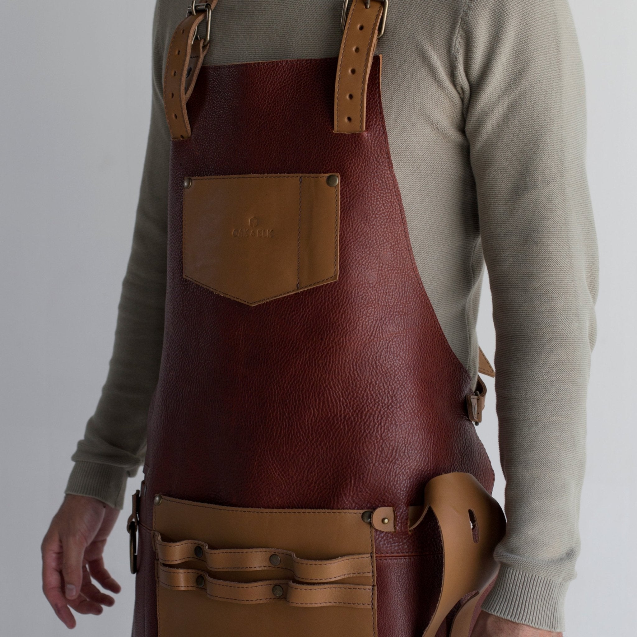 Man wearing leather apron with tools – top reasons to invest in a stylish and functional apron.