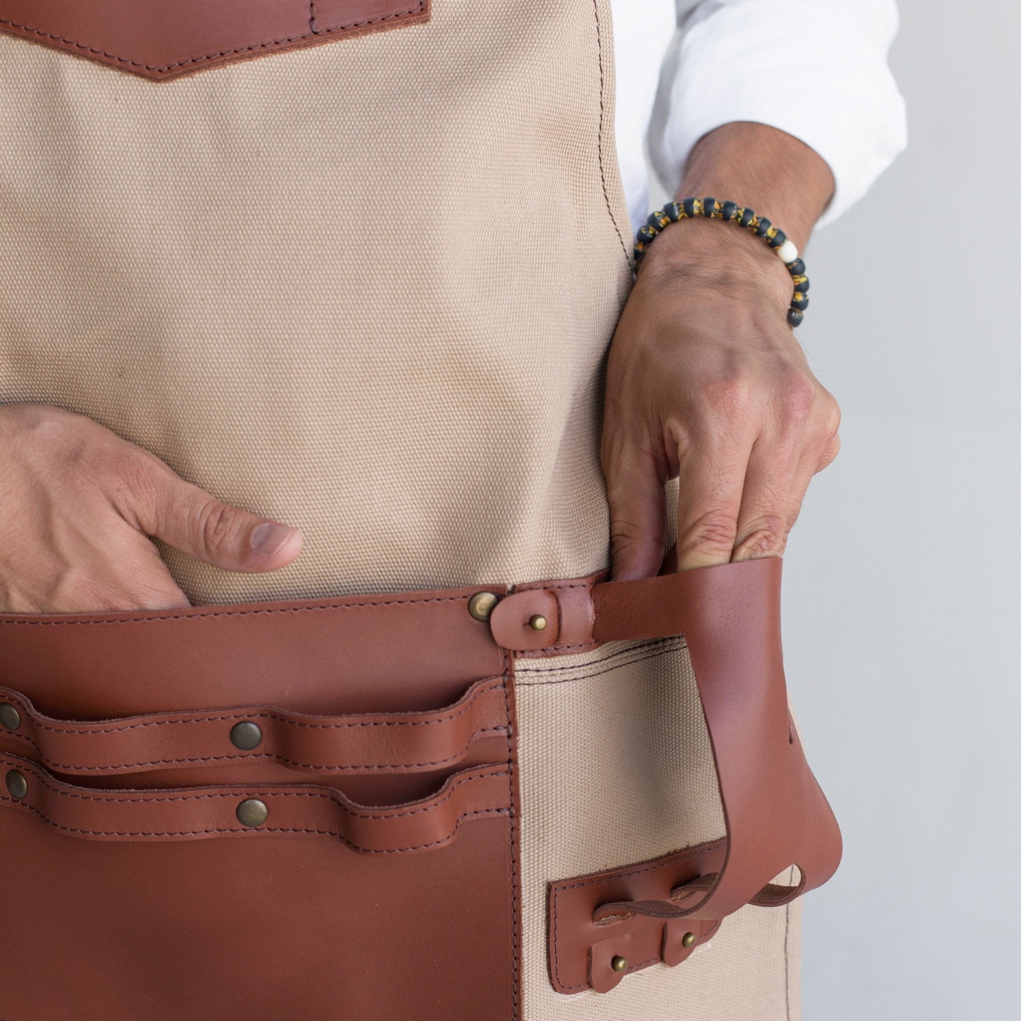 Canvas and leather apron with adjustable straps, chest pocket, and tool loops — durable stylish for grilling, crafts, or work